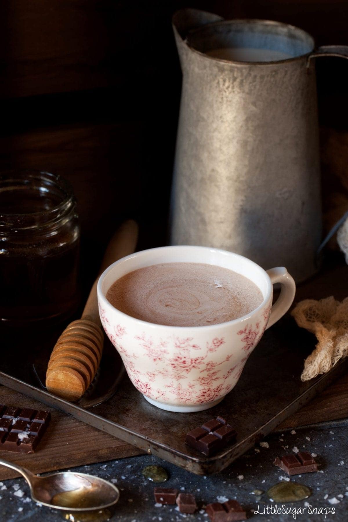 A cup of hot chocolate sweetened with honey.