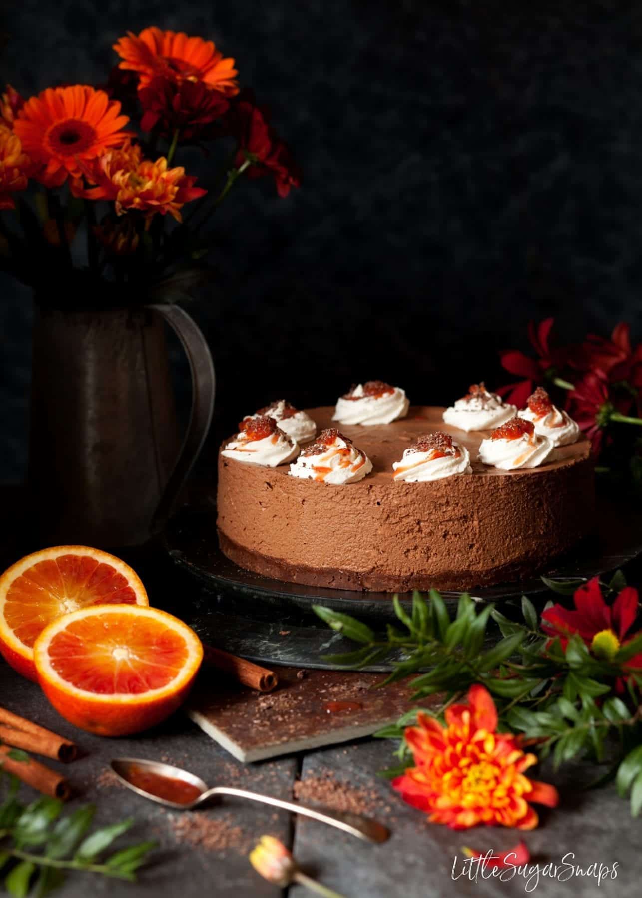 Cinnamon Chocolate Mousse Cake topped with cream and orange compote.