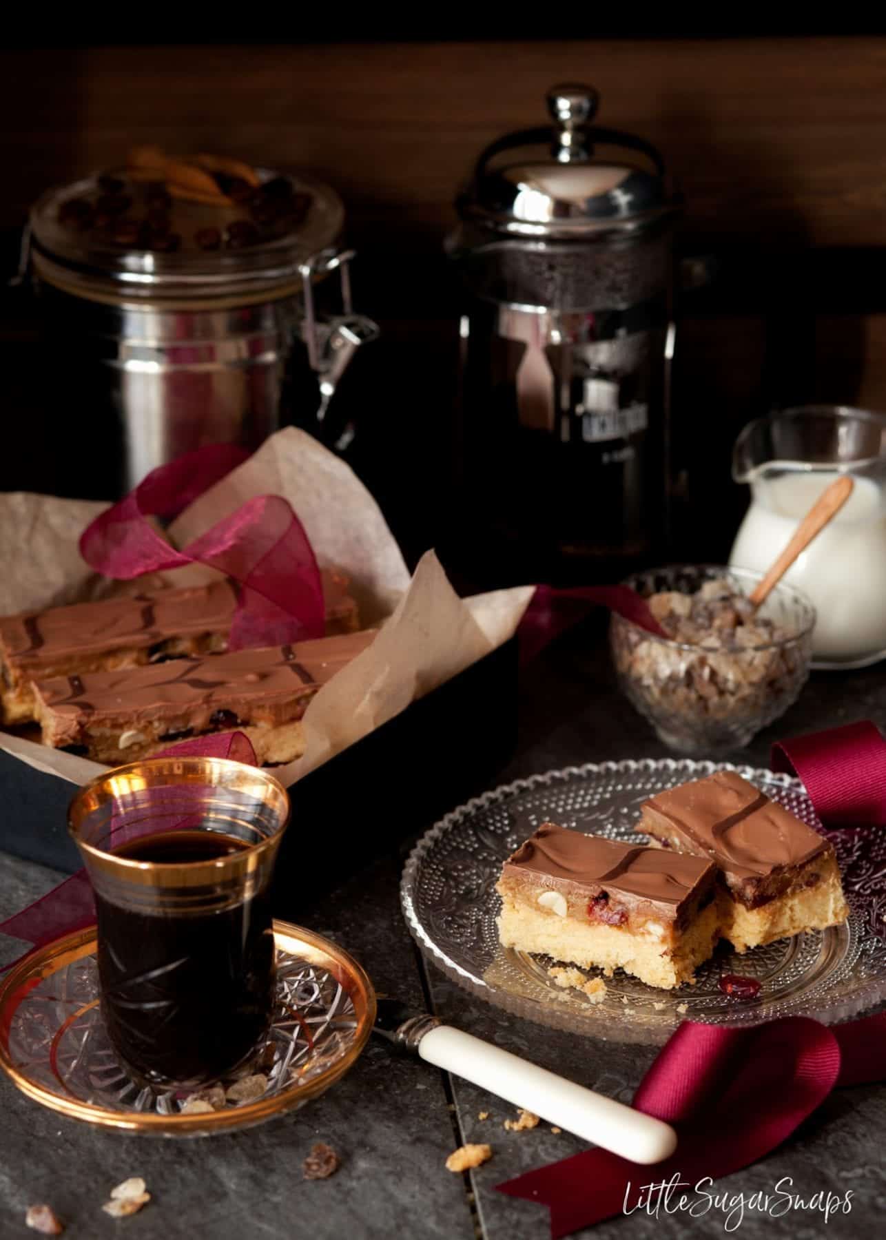 Caramel Shortbread bars with dried cranberries and nuts served with coffee.