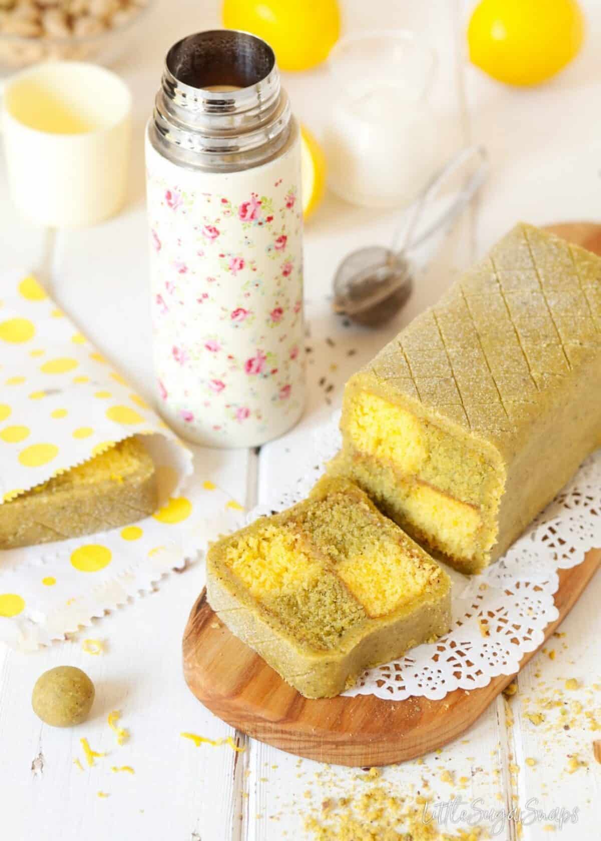 Pistachio and Lemon Battenberg Cake with a slice cut from it.