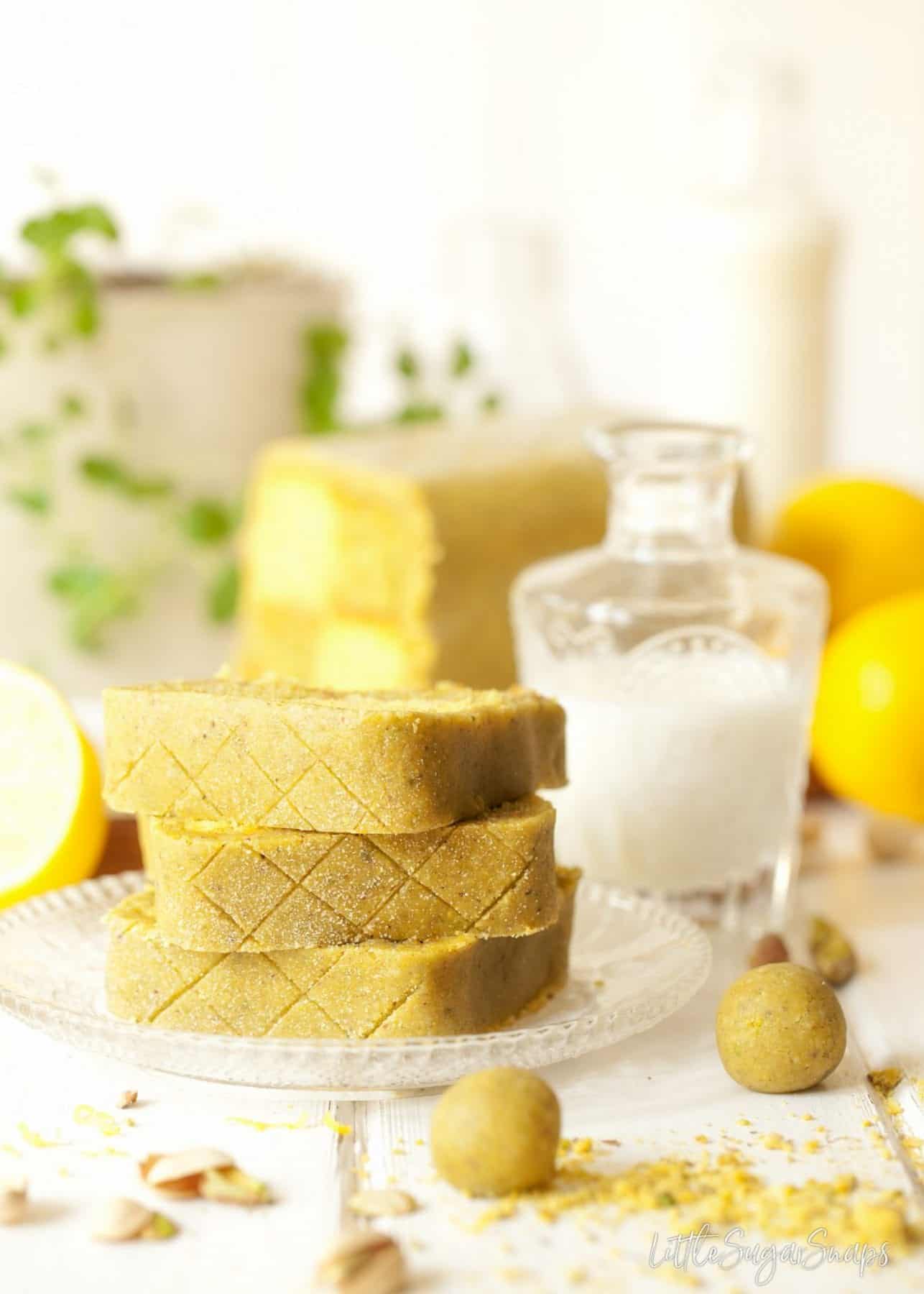 A stack of pistachio marzipan covered cake slices.