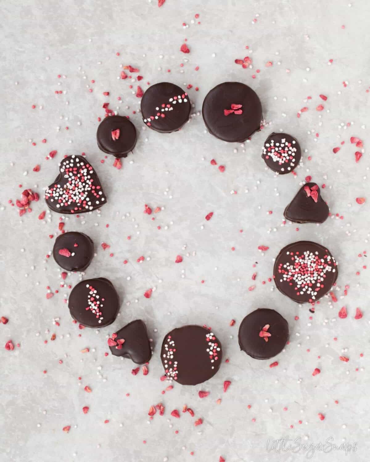 Homemade chocolates decorated with sprinkles and arranged in a circle.
