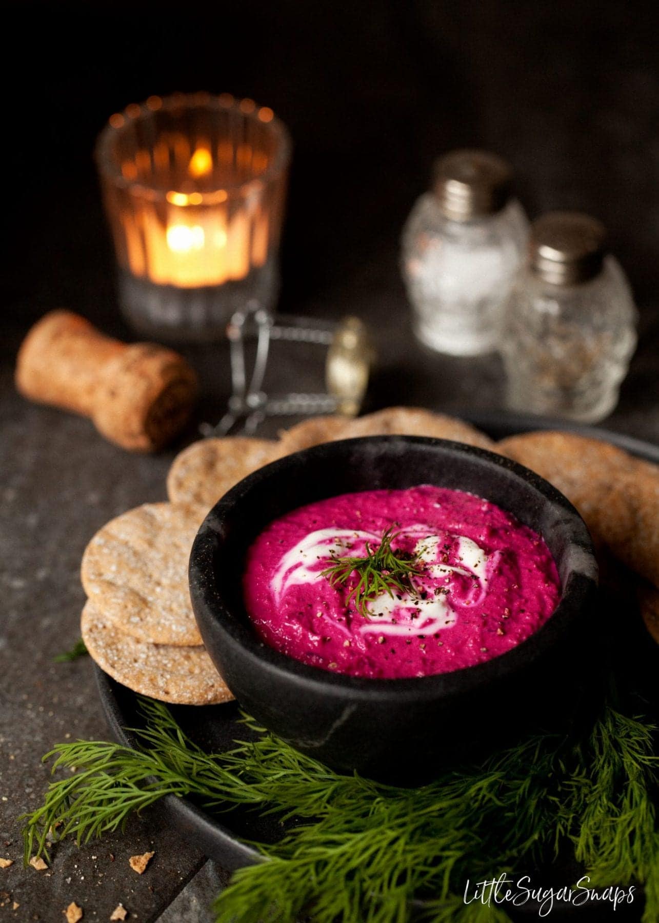 Beet dip with fresh dill and crackers.