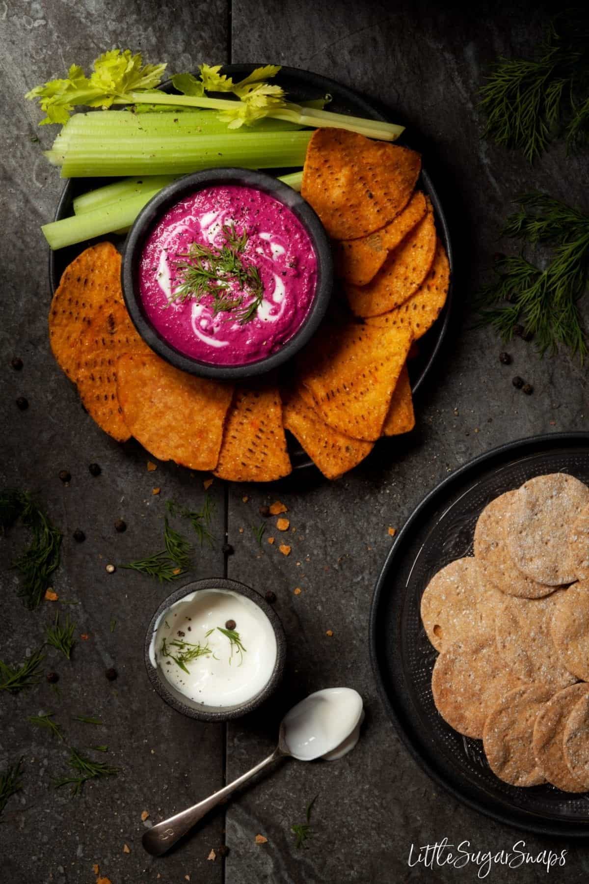 Beetroot Tahini Dip with tortilla chips and crackers.
