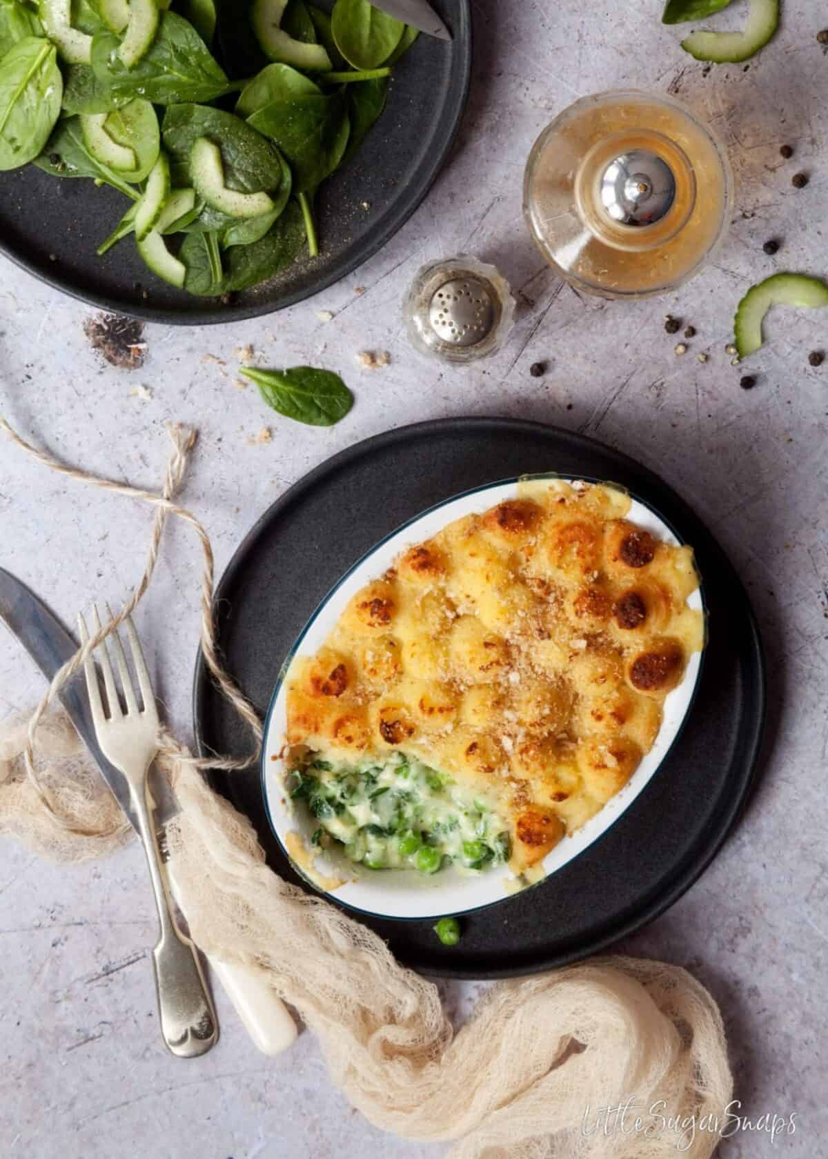 Overhead view of a Cheese and Vegetable Potato Pie with a piece taken out.