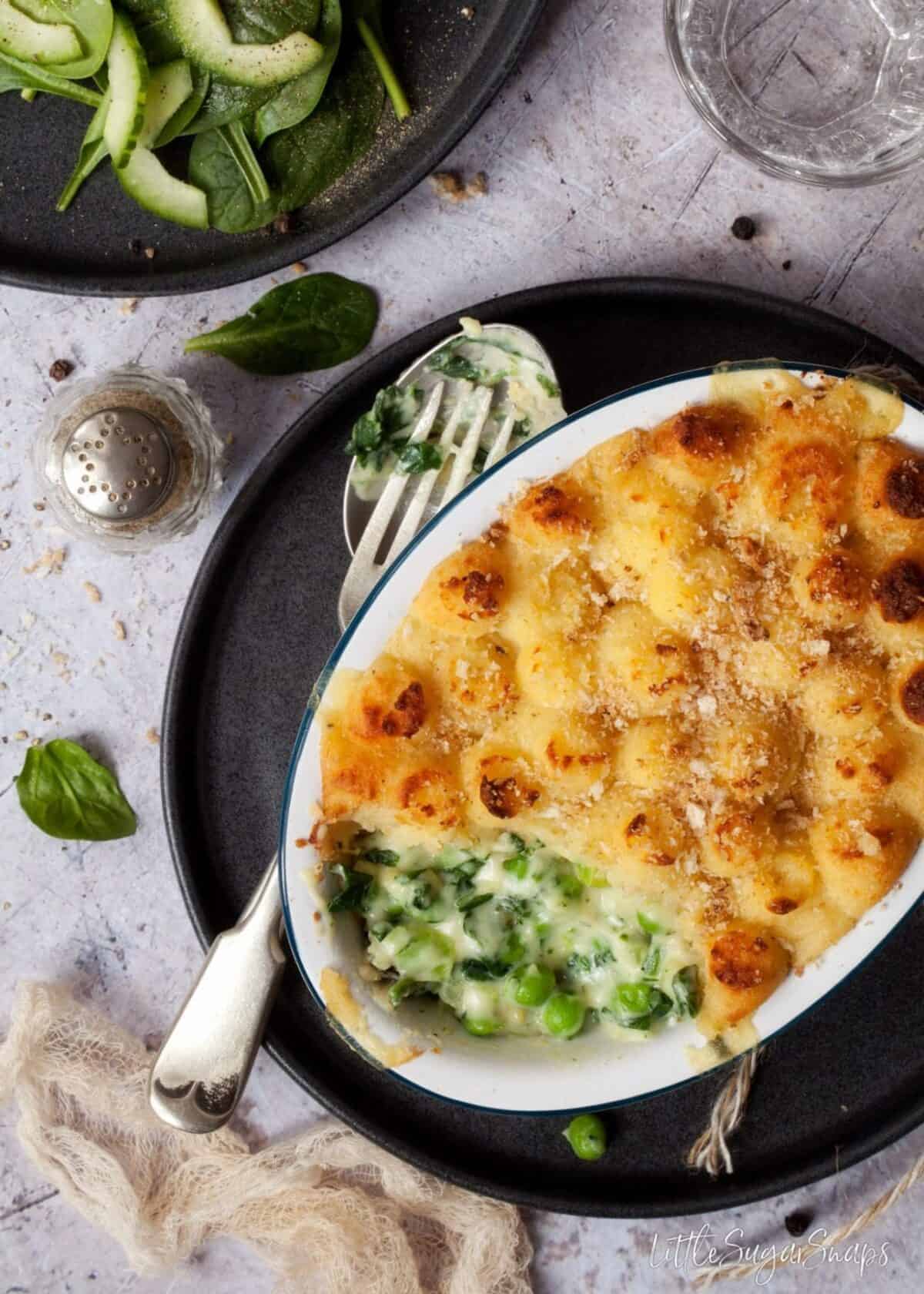 Cheesy Vegetable Potato Pie with a spoonful taken out.