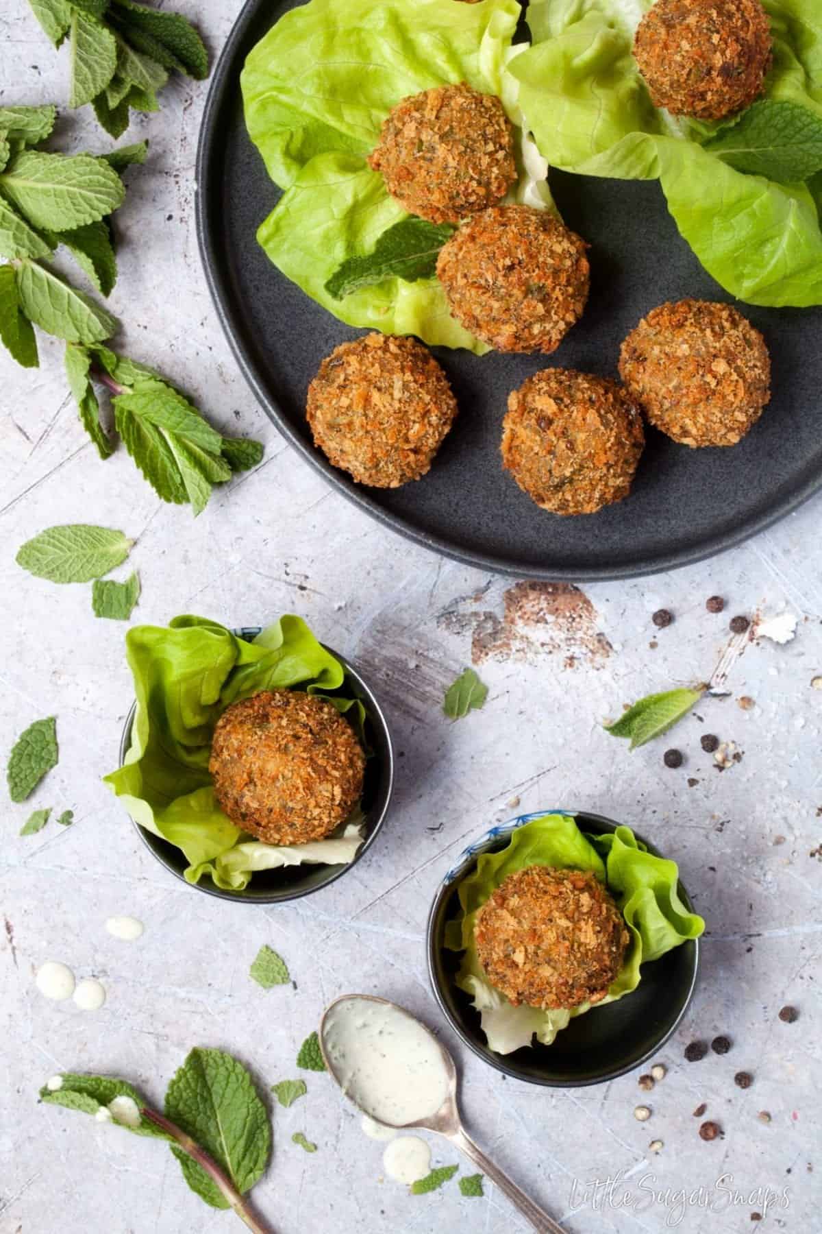 Fried falafels served with lettuce leaves.