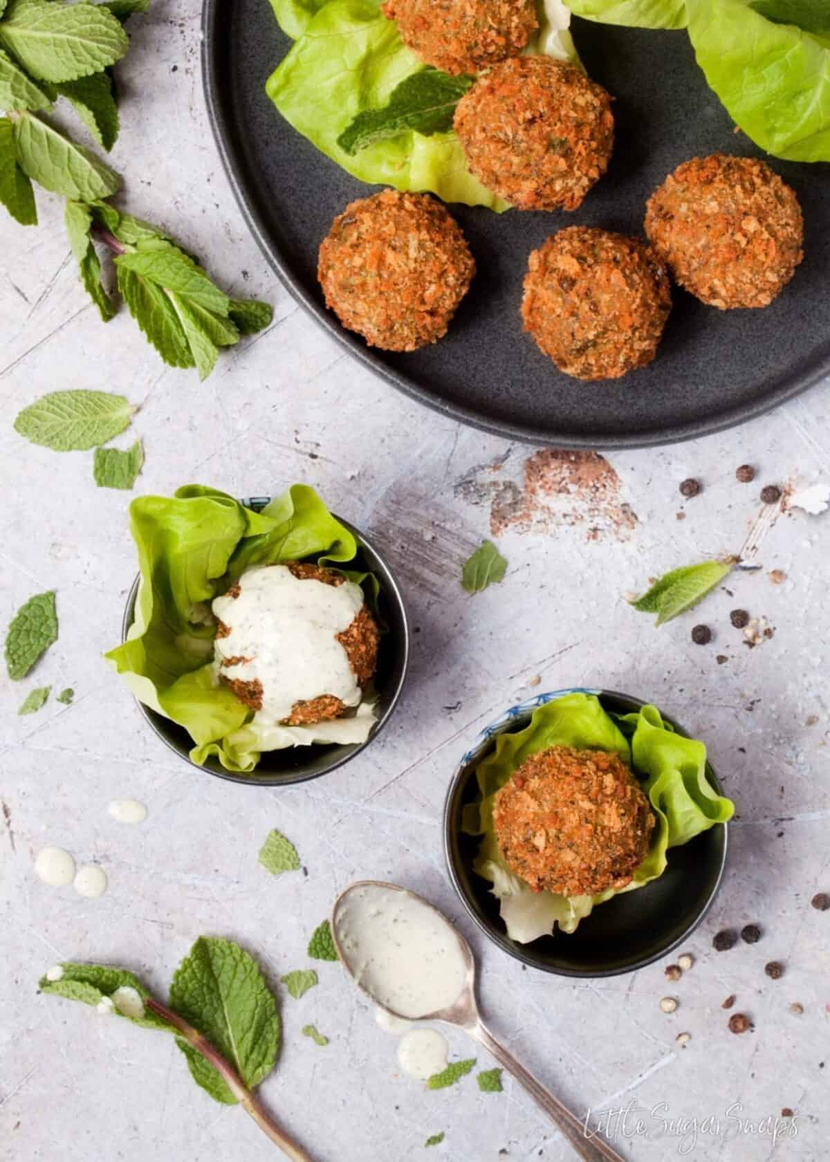 Mint Pea Falafel with mint tahini sauce served on top.