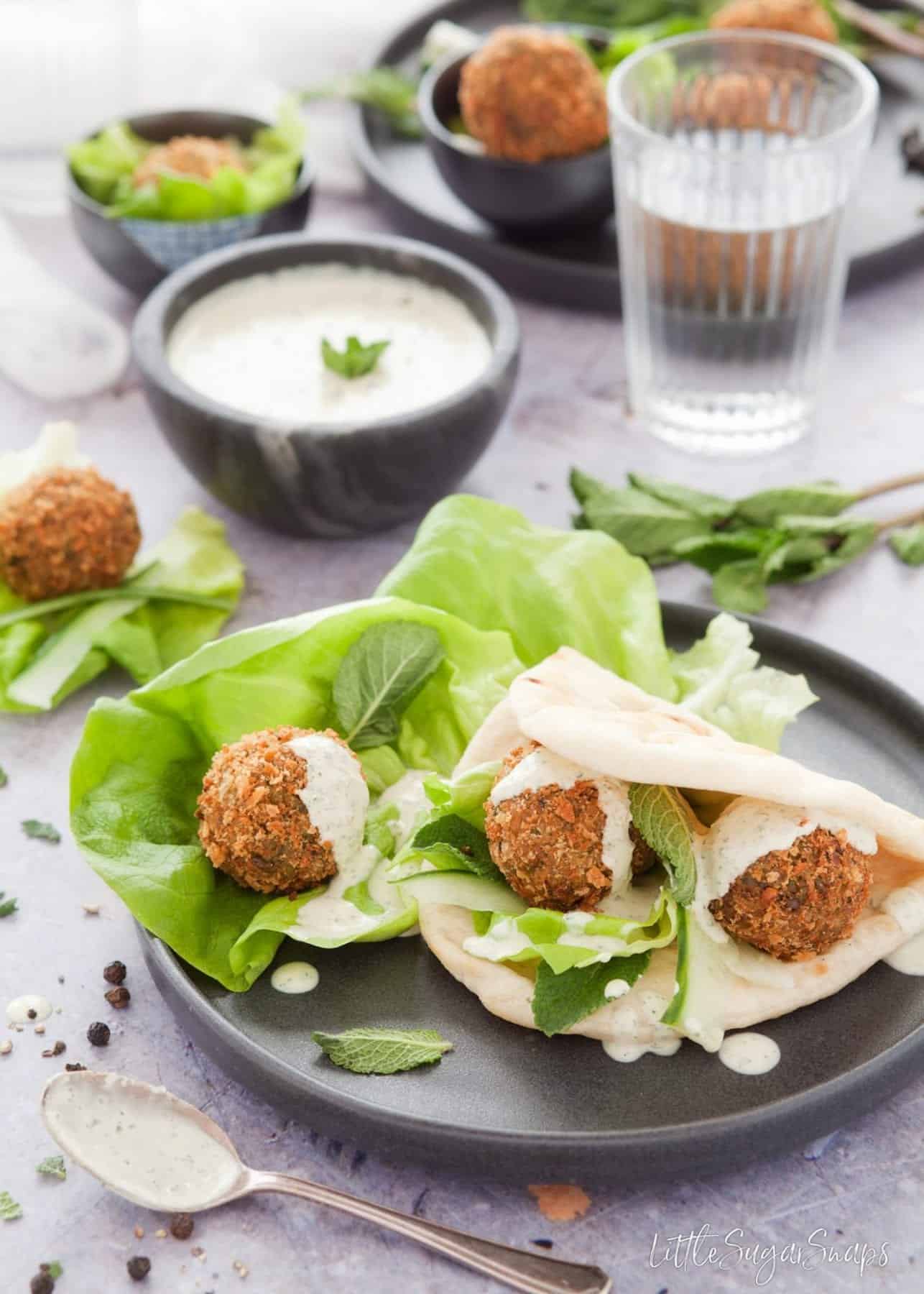 Mint Pea Falafel with flatbrea, salad and tahini sauce.