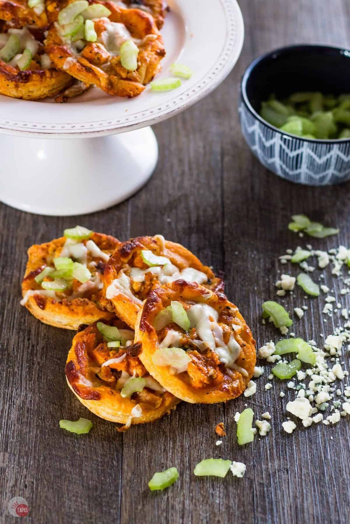 Small bitesized pizza on a wooden table.