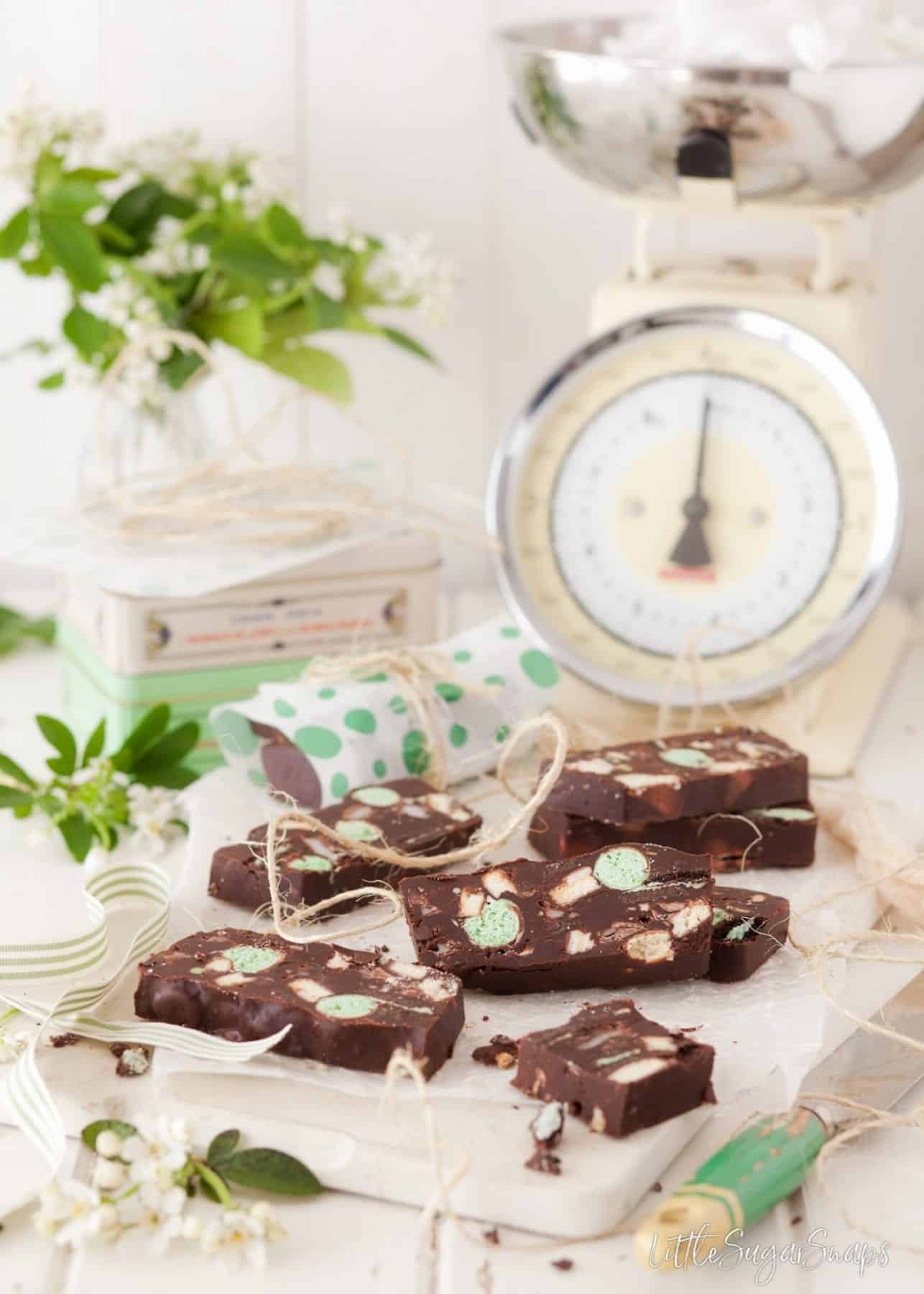 Slices of Mint Chocolate Fridge Cake with old fashioned kitchen scales behind.