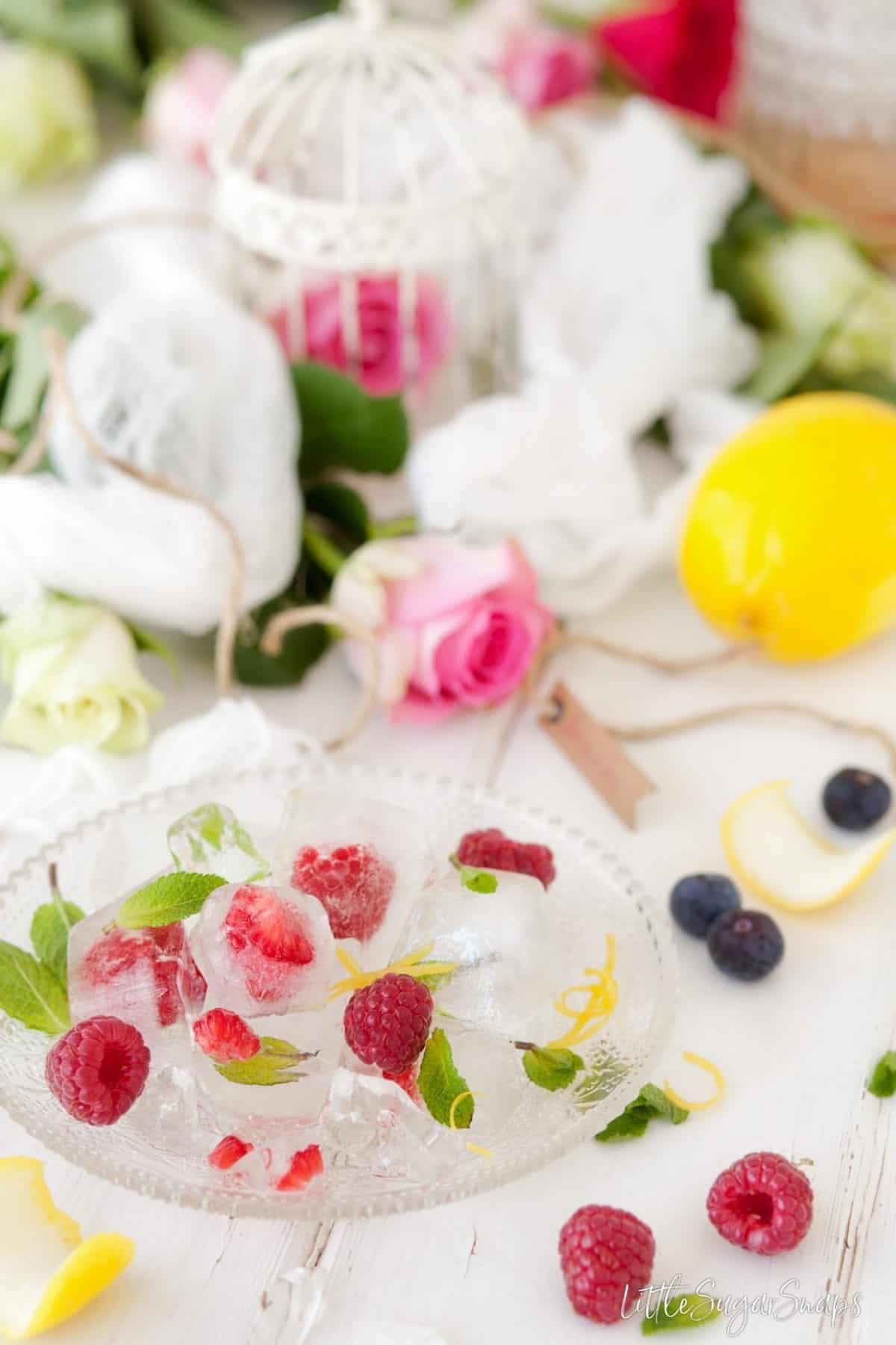 ice cubes with raspberries and mint frozen inside.