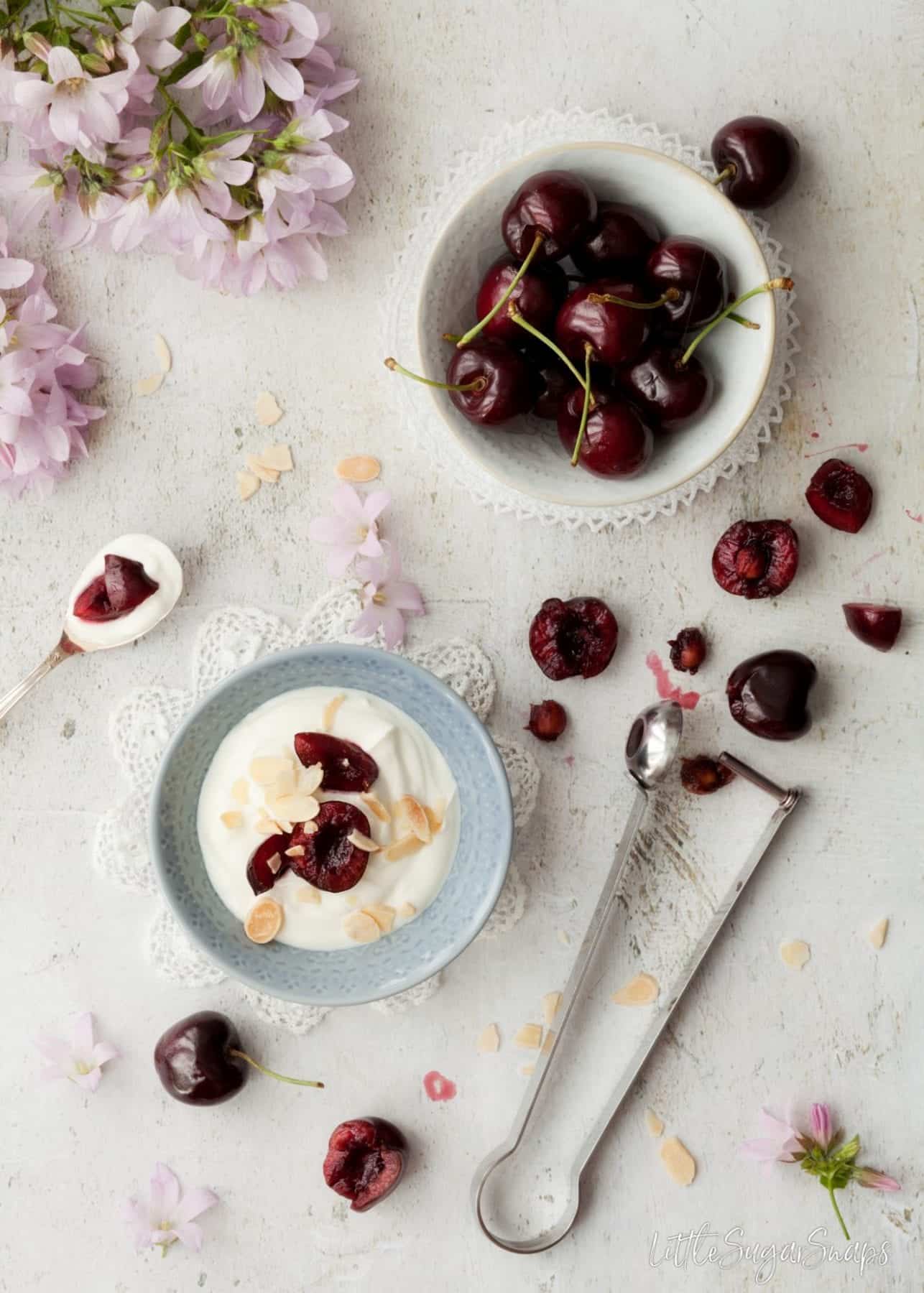 Fresh cherries with a bowl of yoghurt.