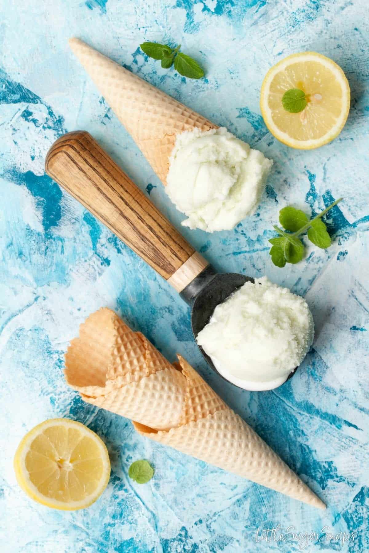 Waffle cones with limoncello lemon sorbet on a blue background.