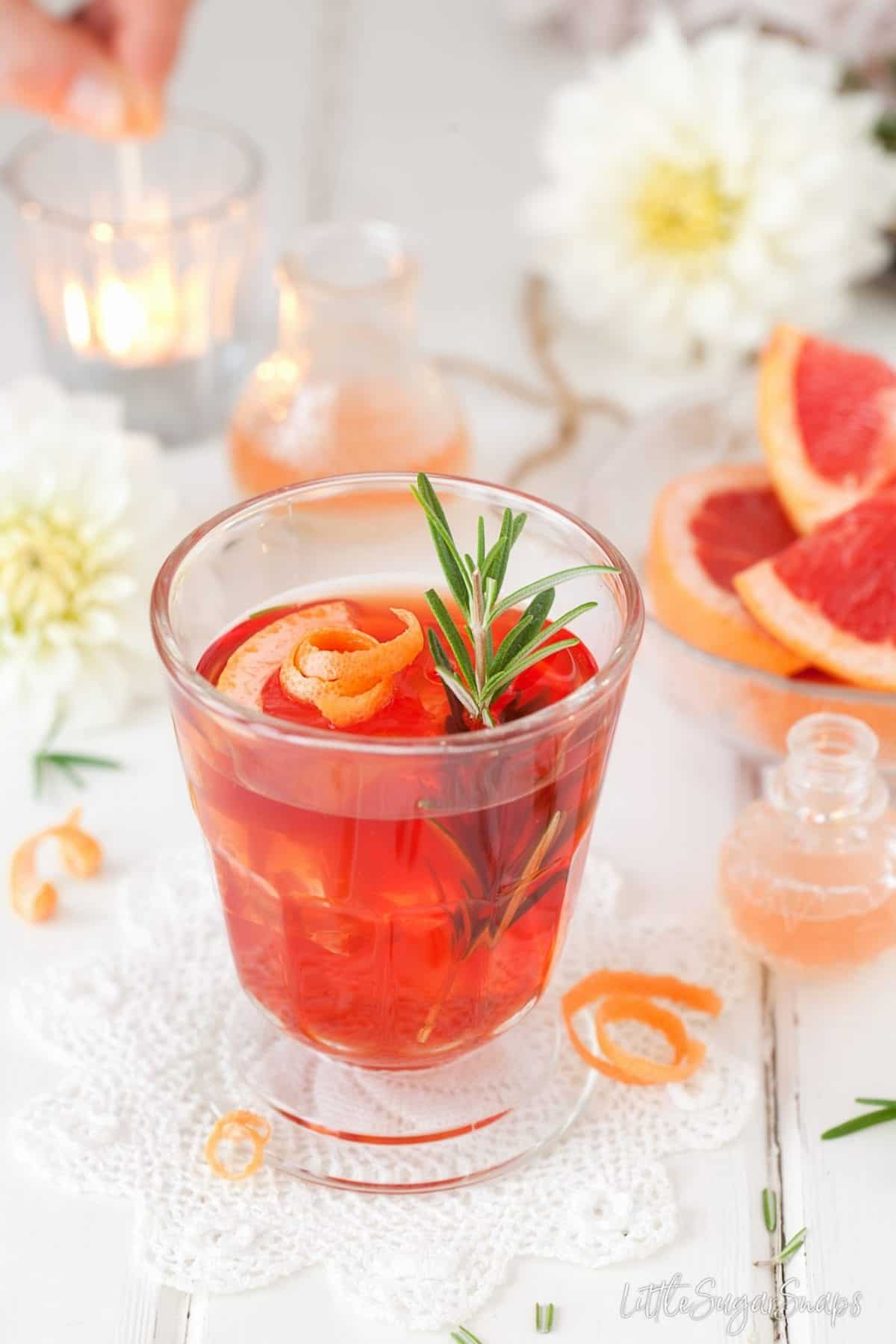 Grapefruit Negroni garnished with fresh rosemary and grapefruit.