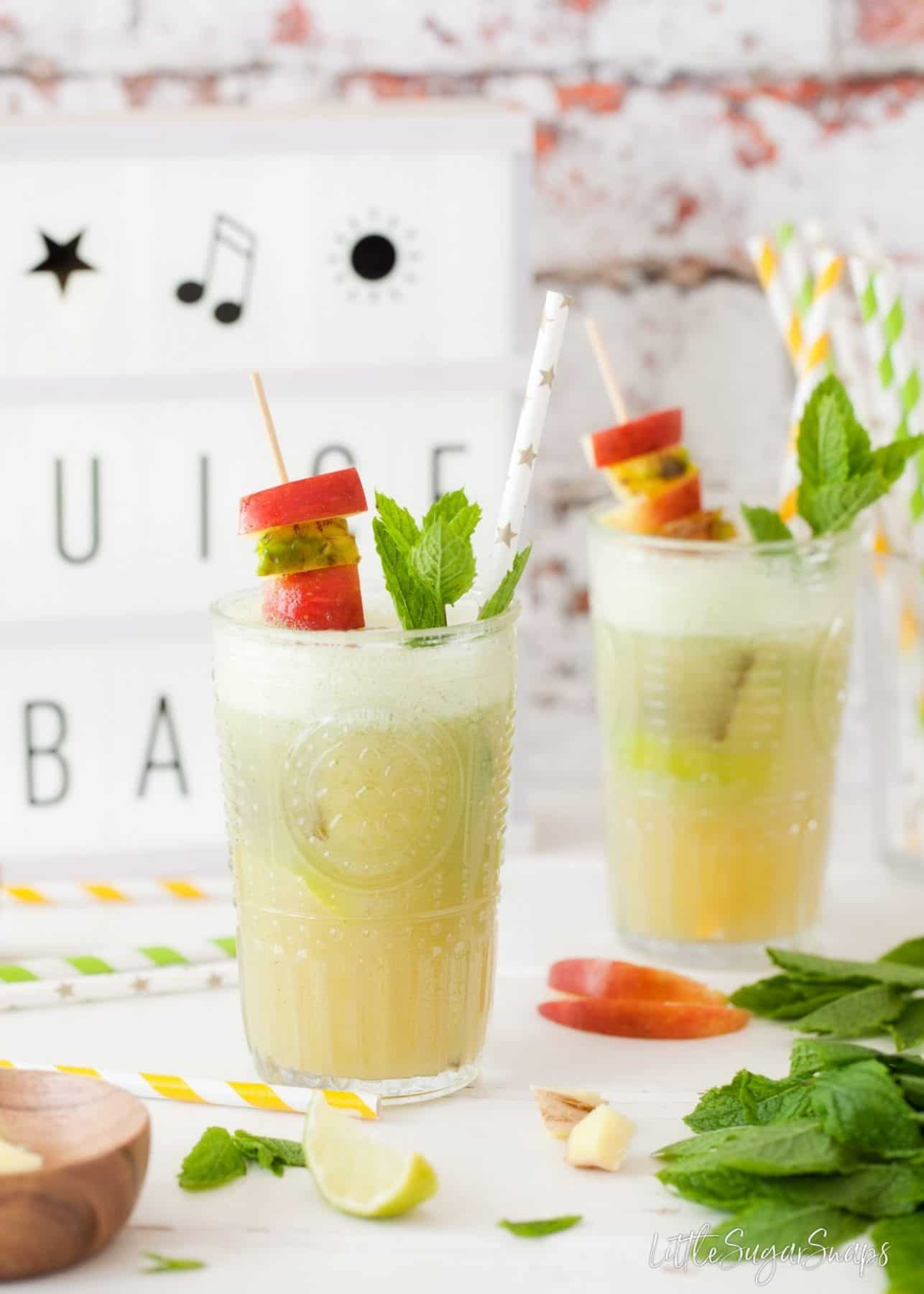 Apple Pineapple Ginger Juice garnished with fruit skewers.