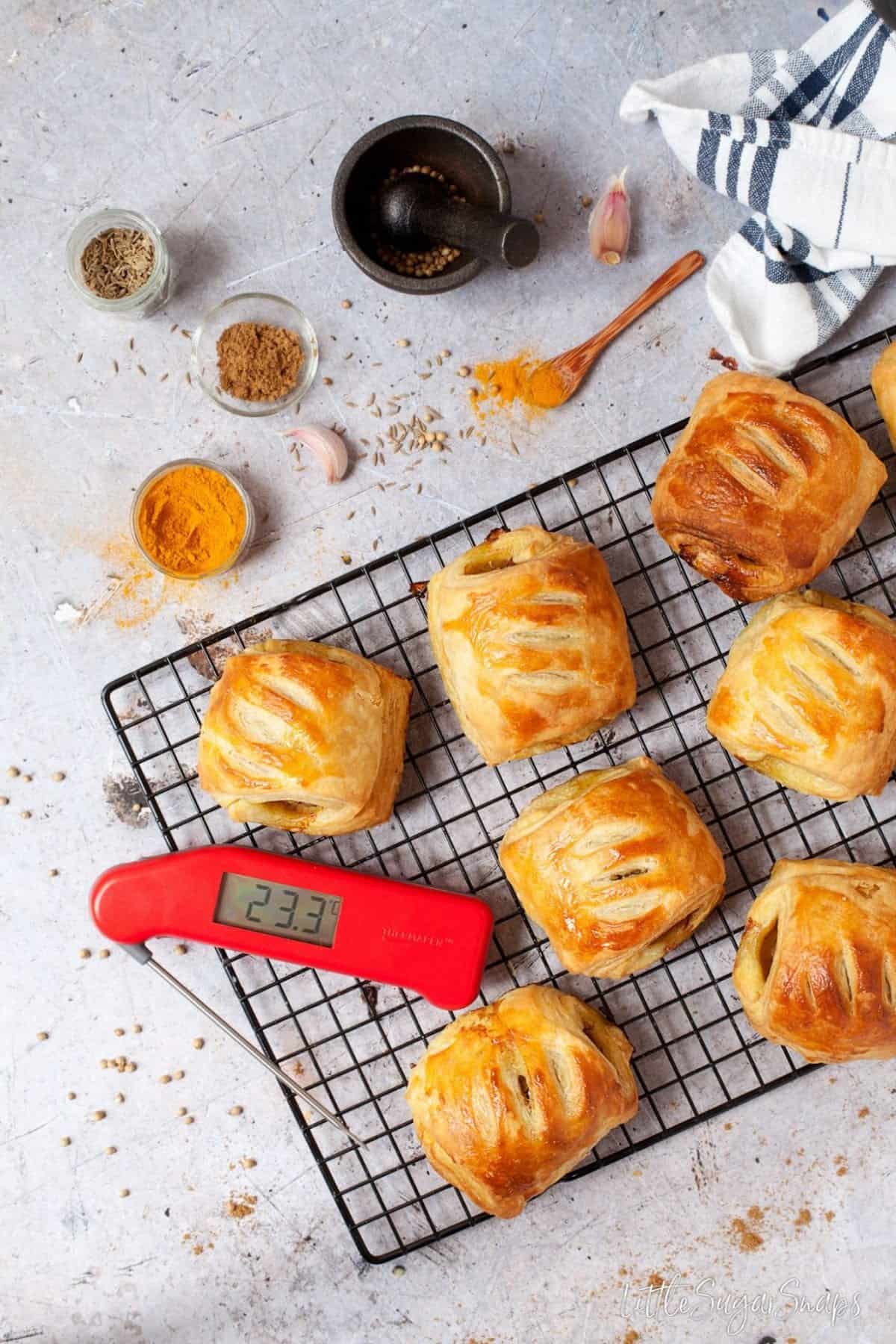 Bombay spices and Lamb Rolls in puff pastry on a cooling rack