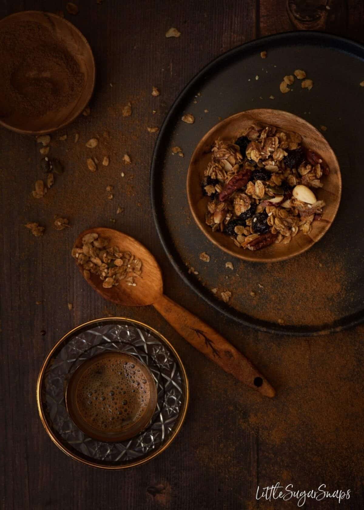 Homemade granola with a cup of black coffee alongside.