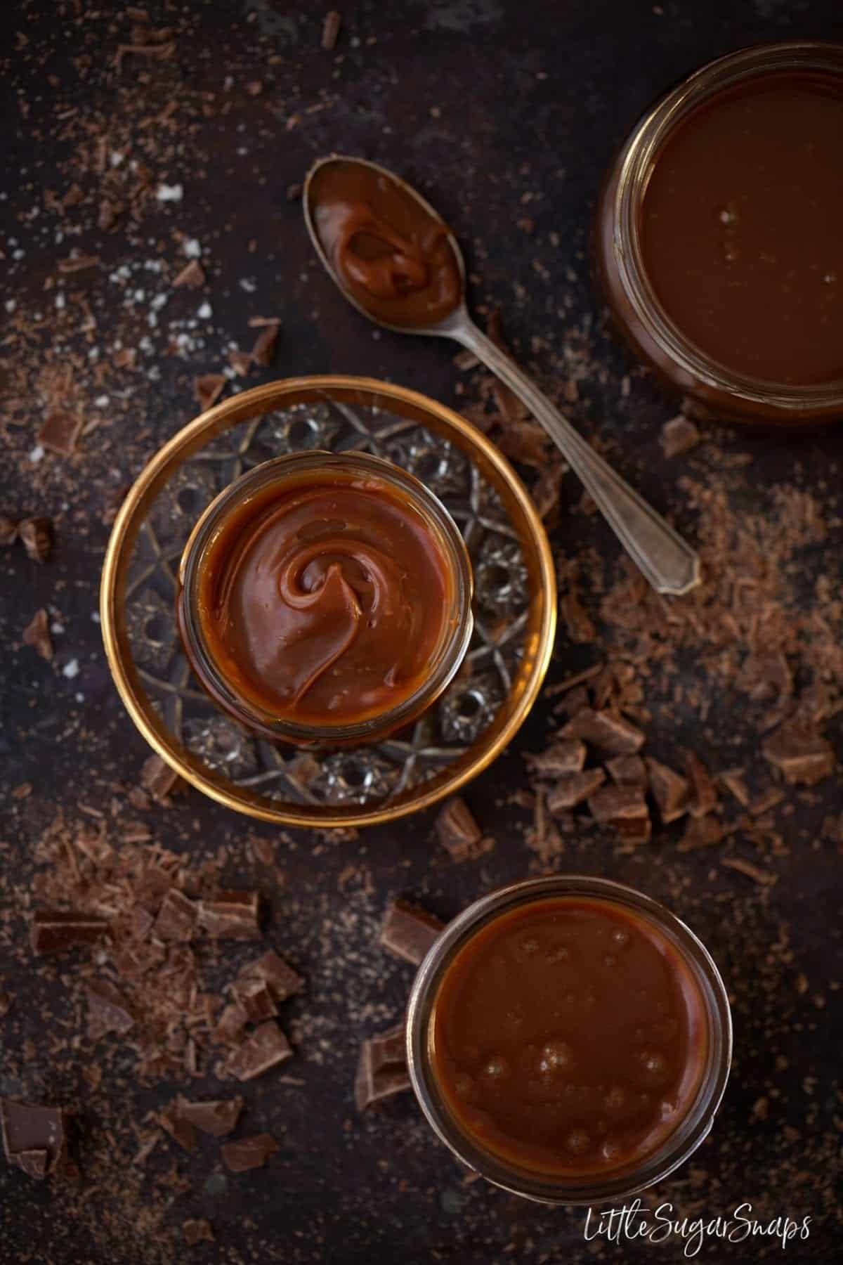 Chocolate Caramel Spread in small jars with chopped chocolate alongside.