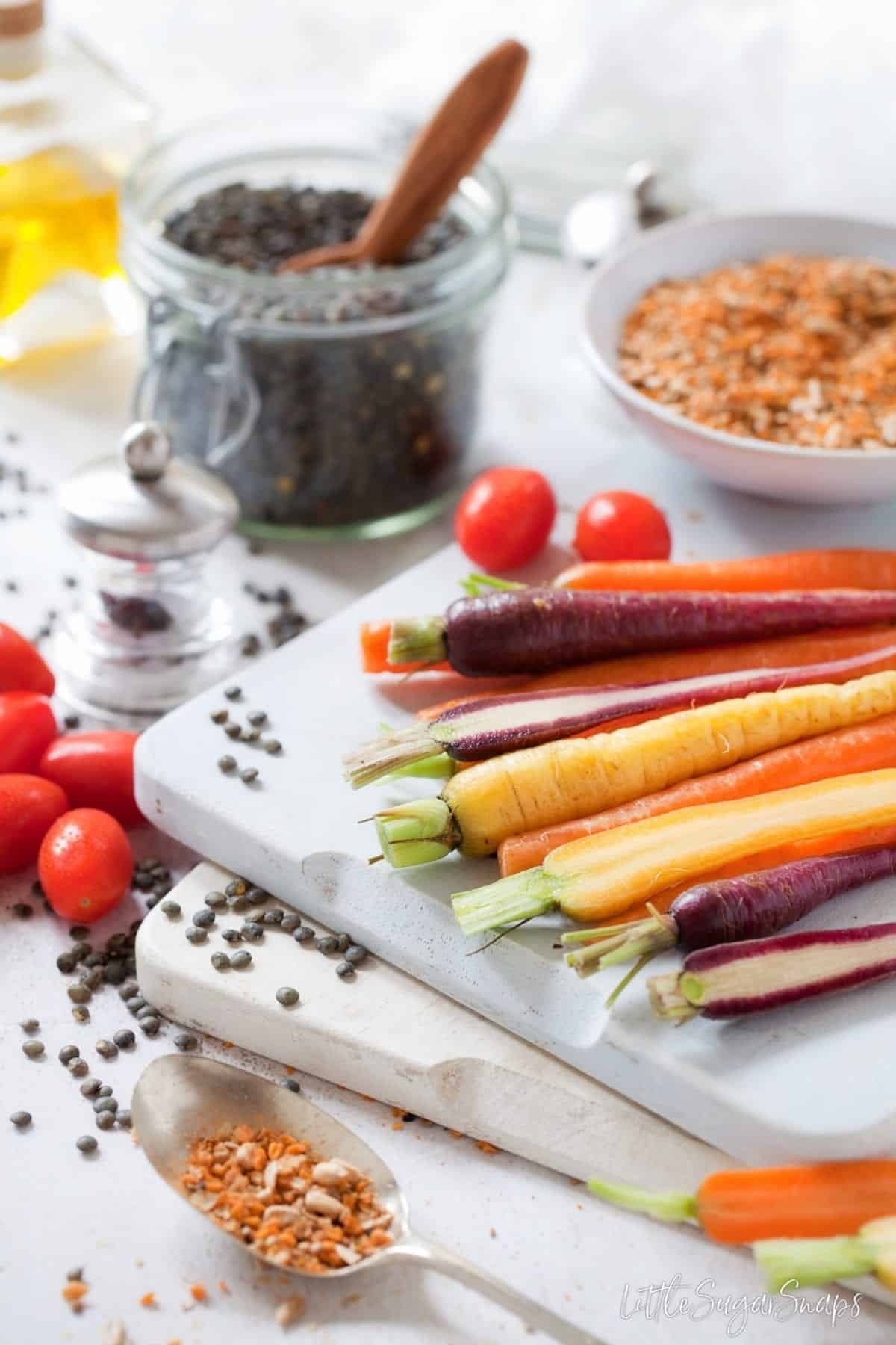 Ingredients: vegetables on a chopping board and dukkah on a spoon.