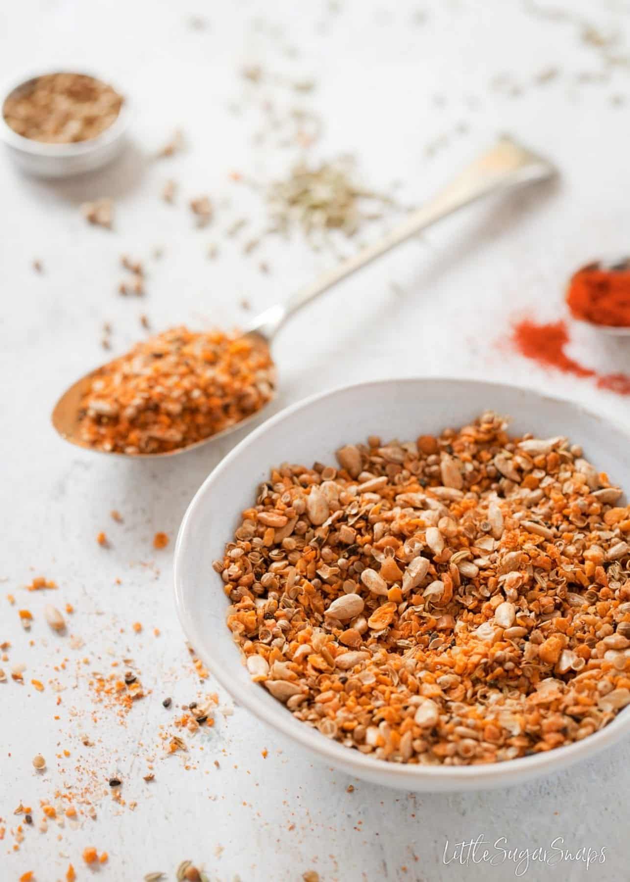 Close up of a bowl of dukkah spice seasoning.