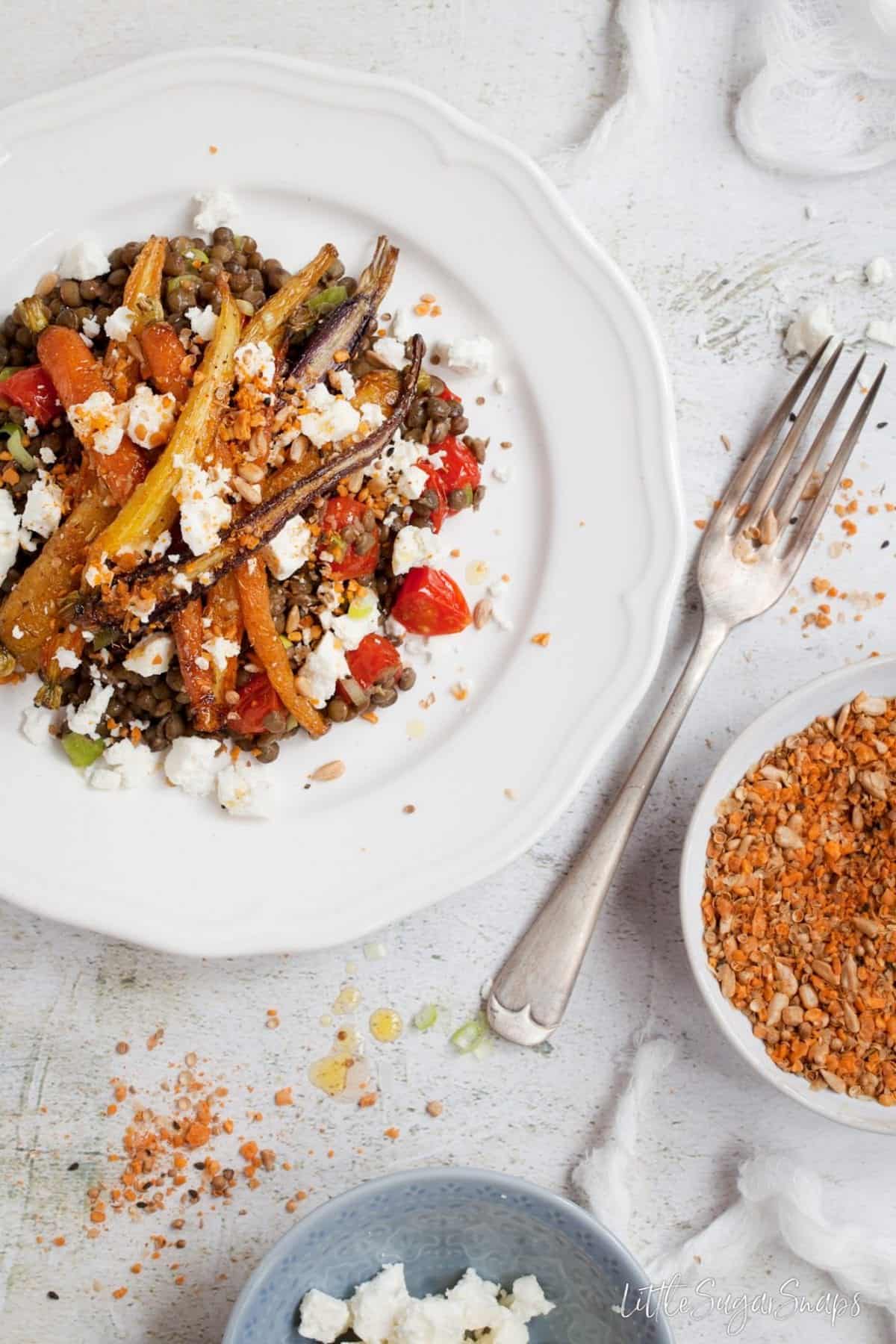 Overhead view of Roast Carrot and Lentil Salad scattered with feta and dukkah.