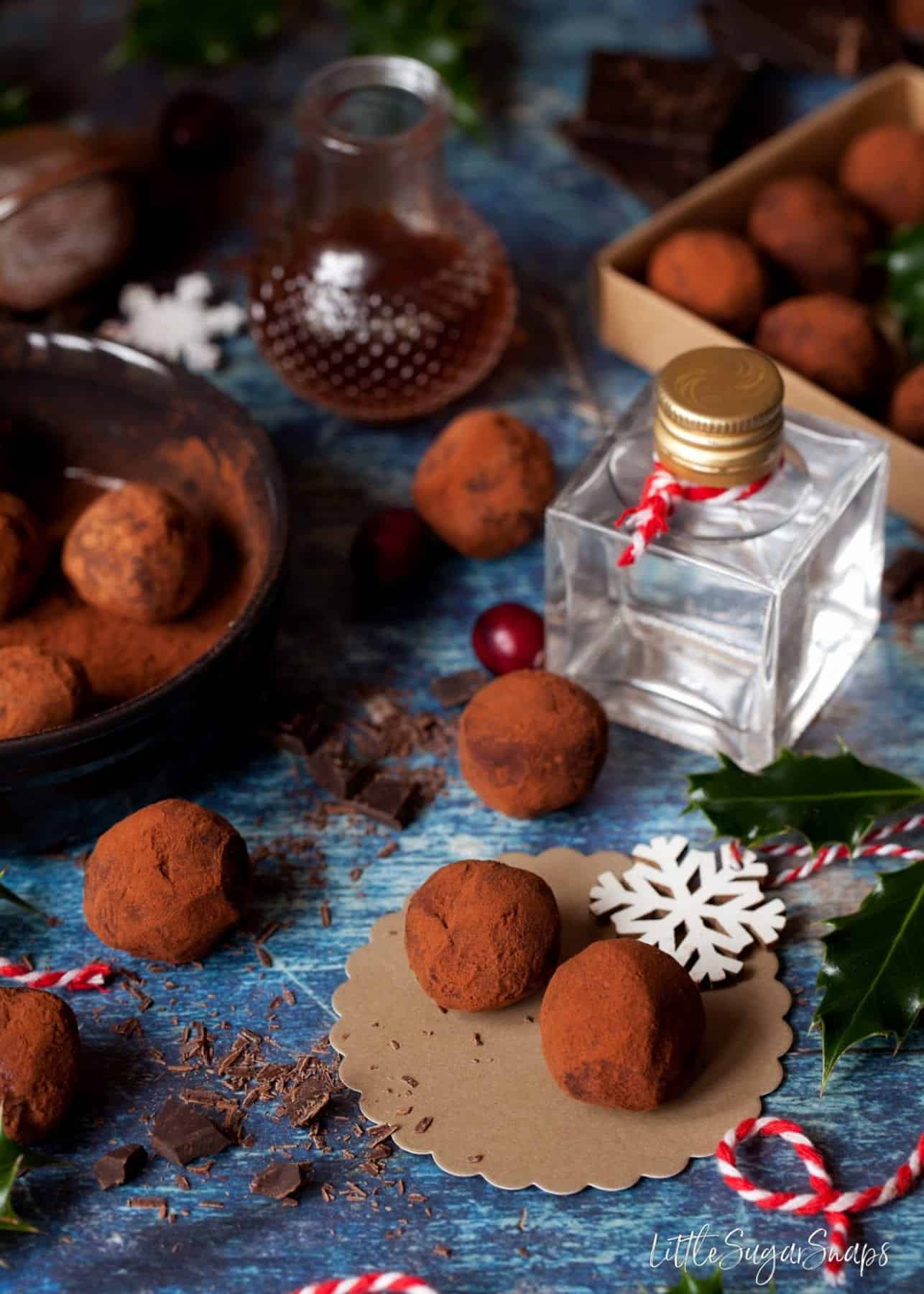 Gin and Tonic Truffles with a mini bottle of gin behind them.