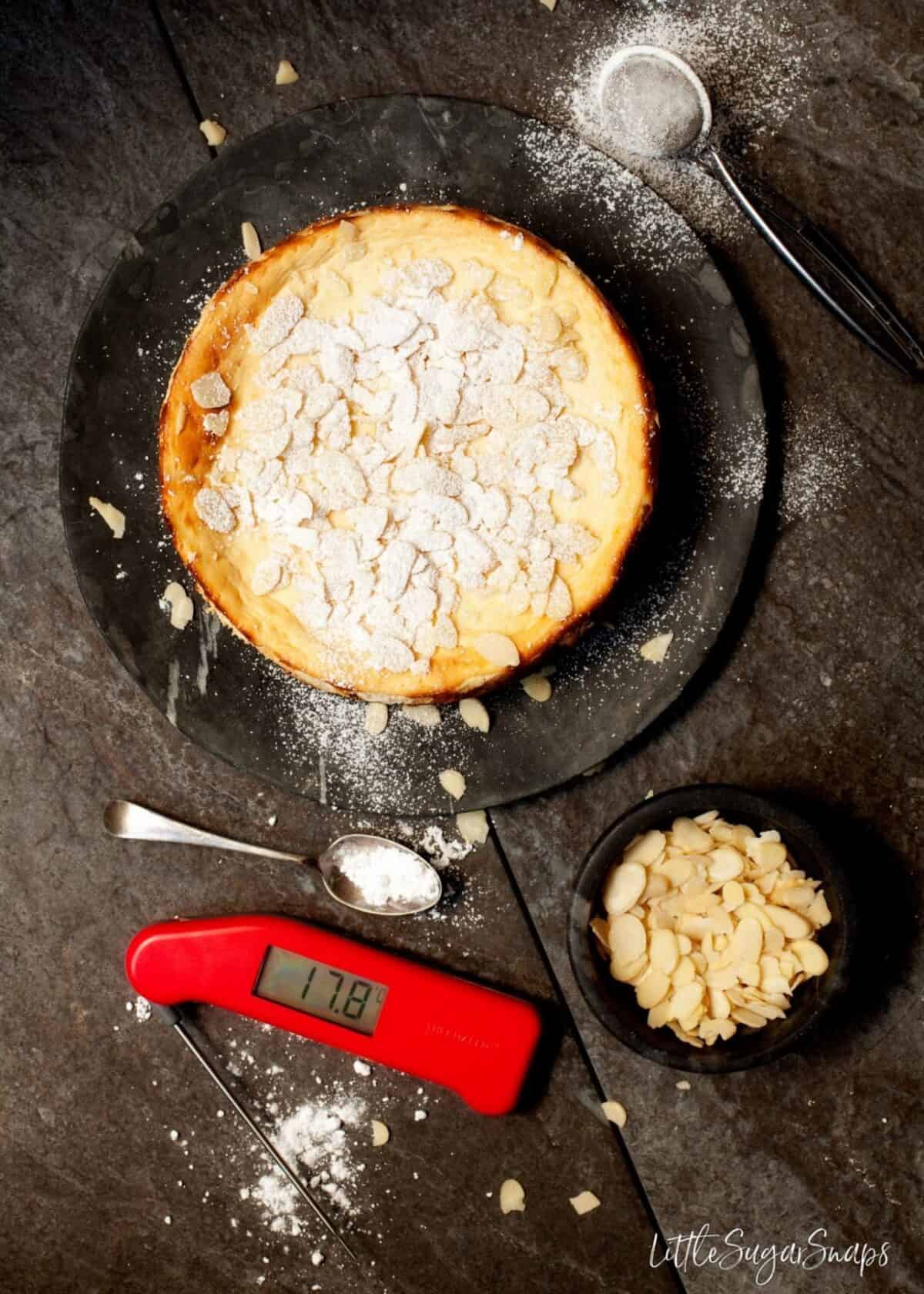 overhead view of Italian Ricotta Cheesecake with a digital food thermometer alongside.