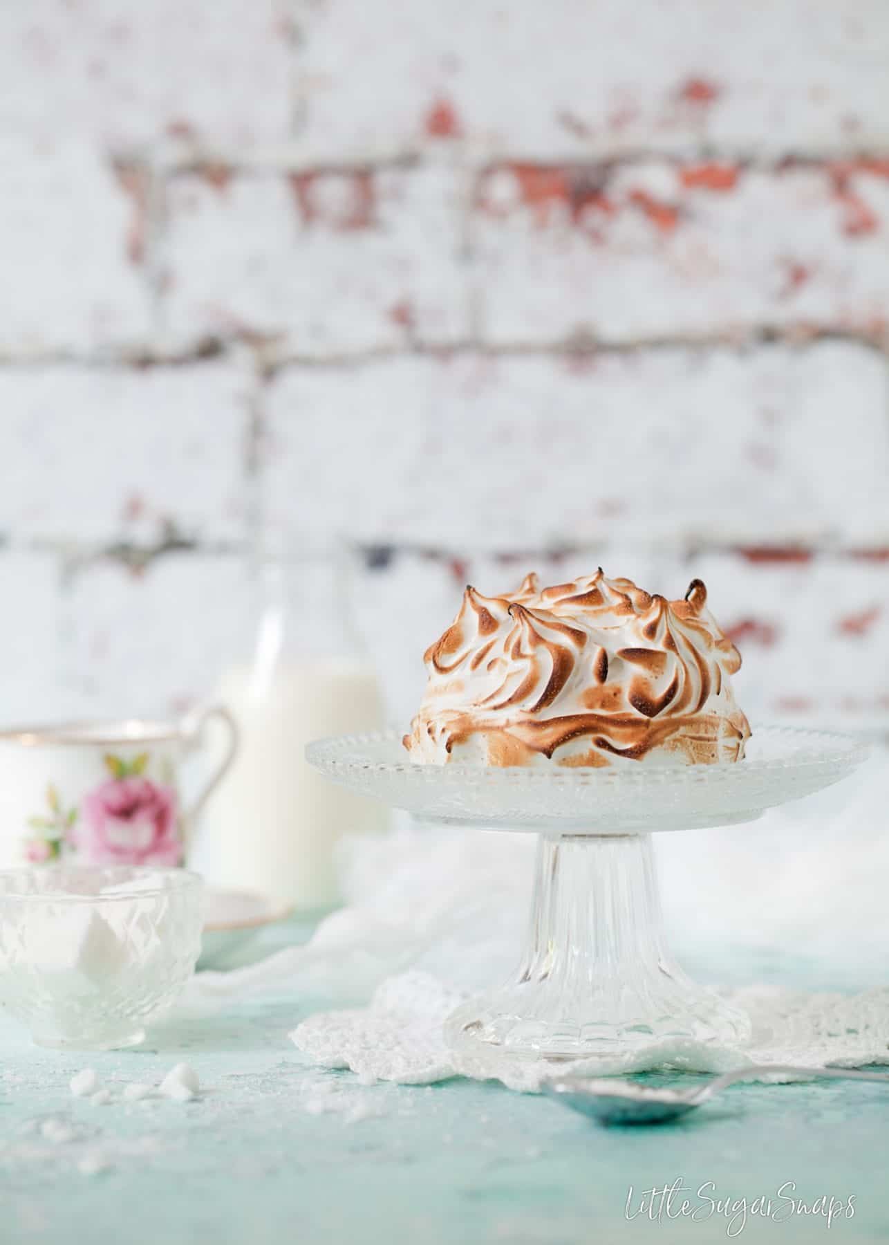 Toasted meringue dessert on a cake stand
