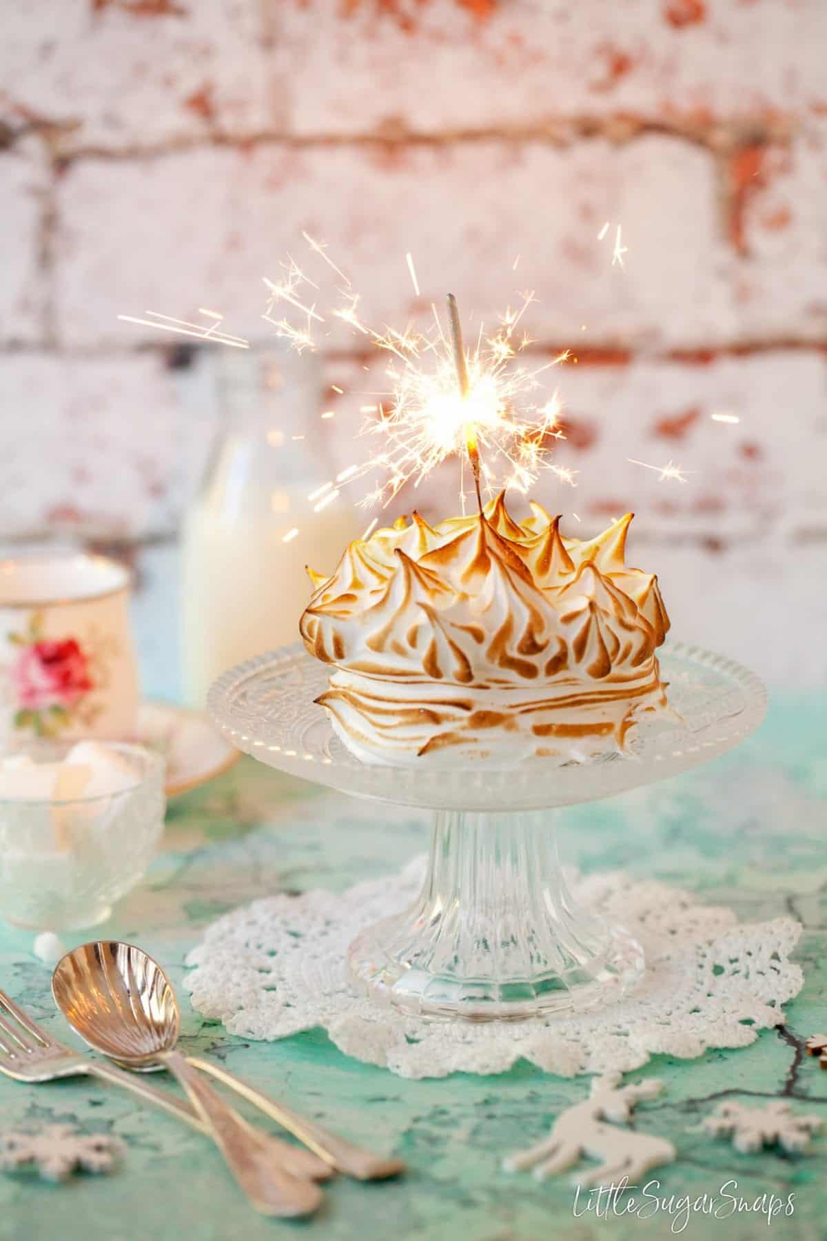 A mini baked alaska with a lit sparkler on top