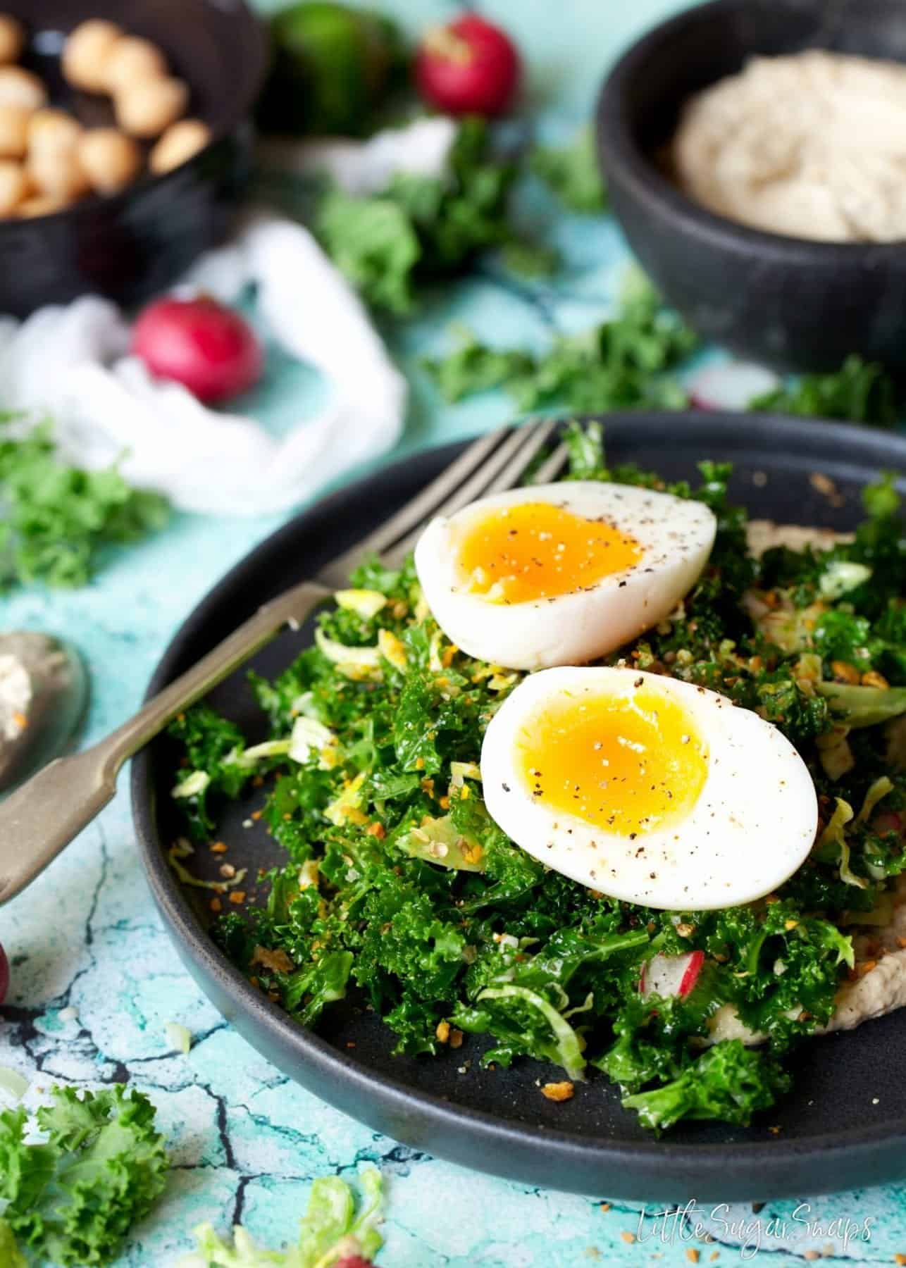 Close up of soft boiled egg on Kale and Sprout Salad