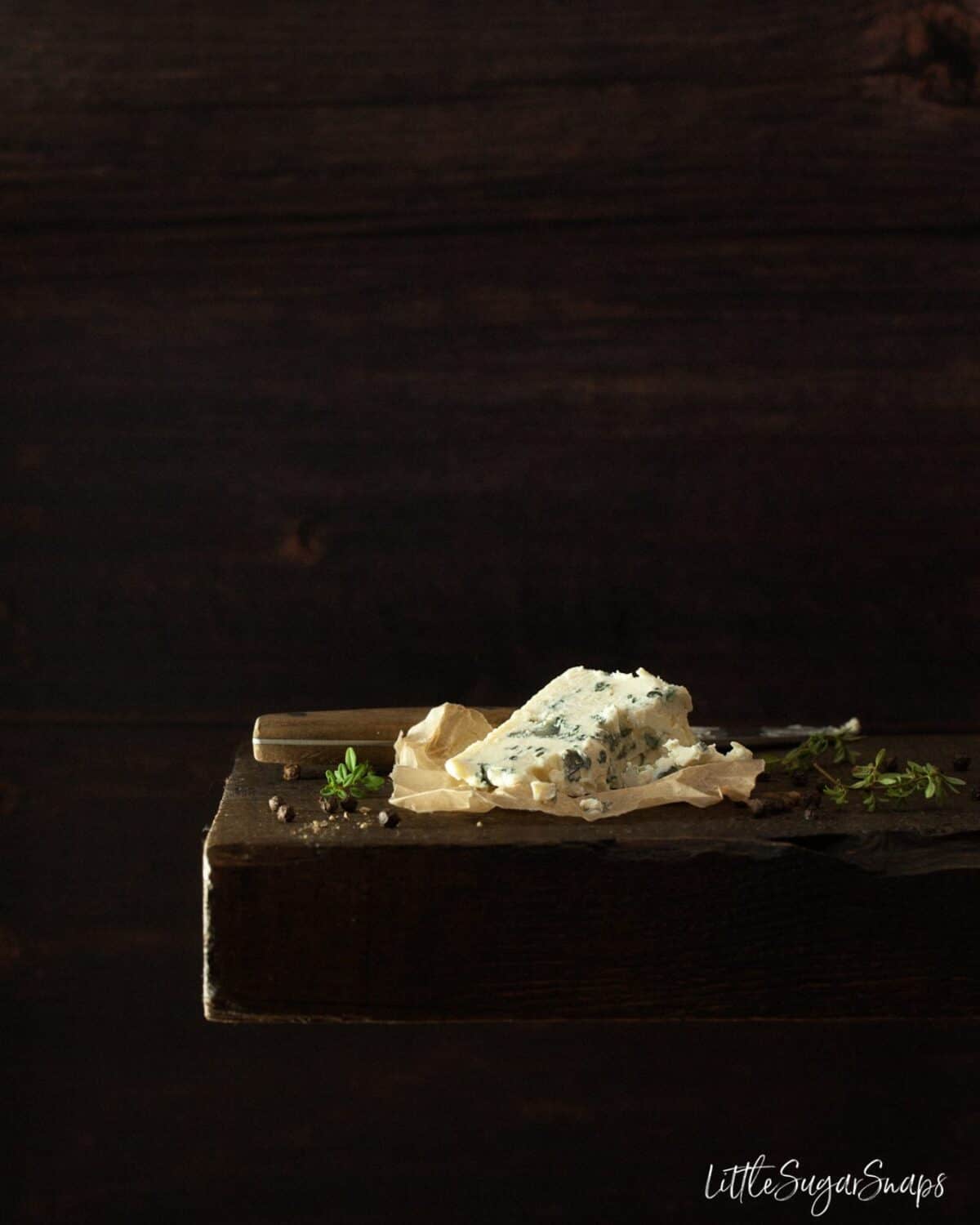 Blue cheese on a wooden board.