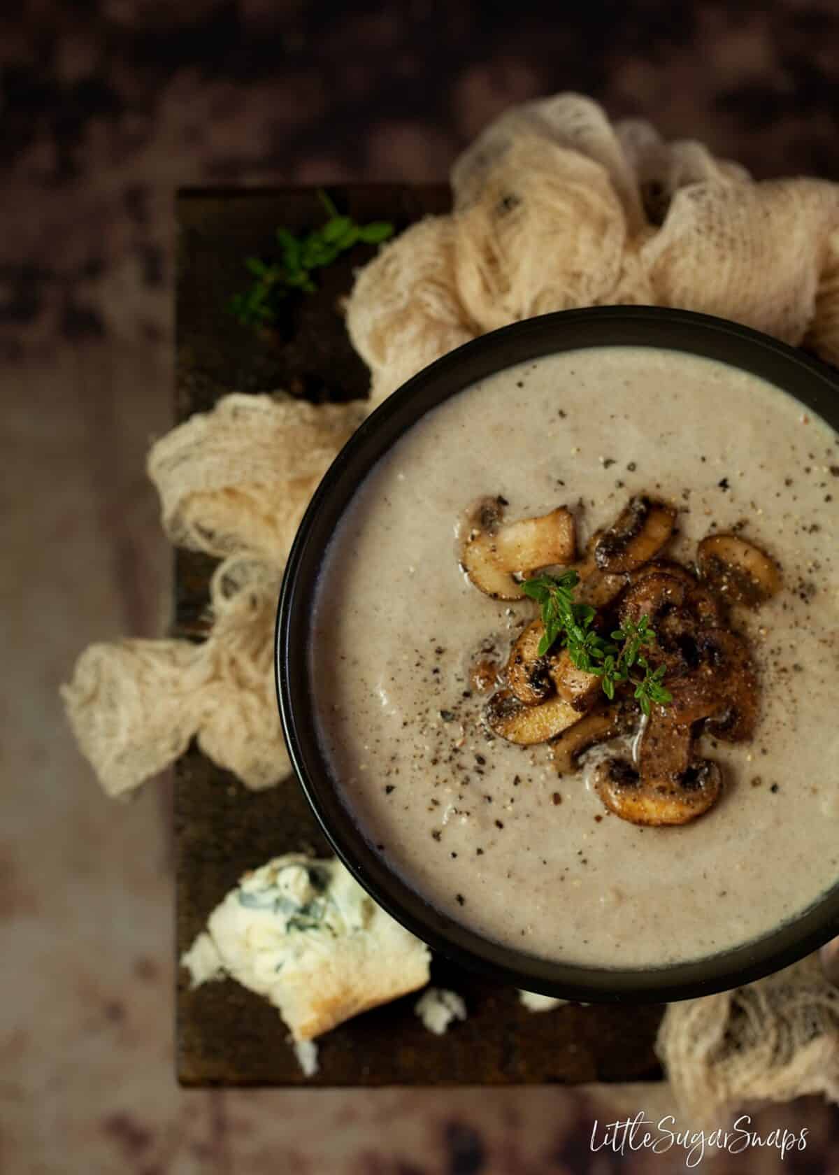 Close up of Mushroom Thyme & Blue Cheese Soup with fried mushroom garnish