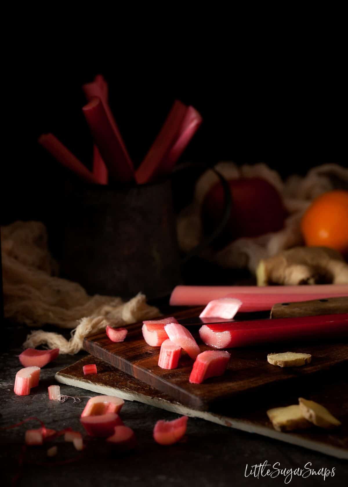 Chopped forced Rhubarb on a chopping board.