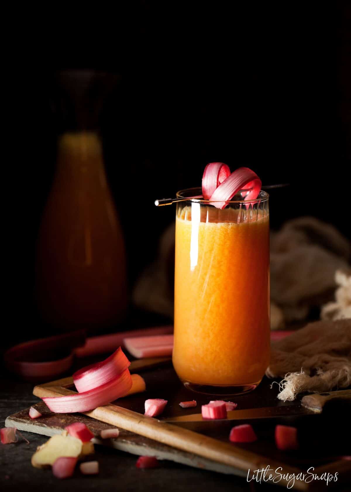 Rhubarb Juice garnished with a strip of rhubarb.