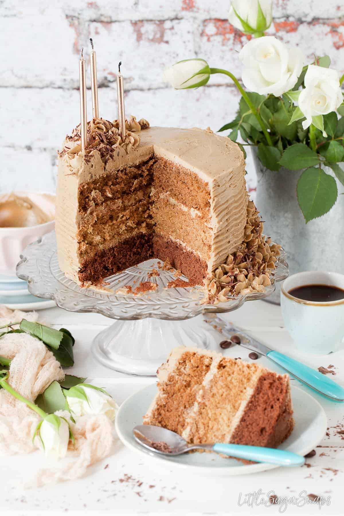 Coffee flavoured sponge cake cut into to reveal three different coloured layers inside