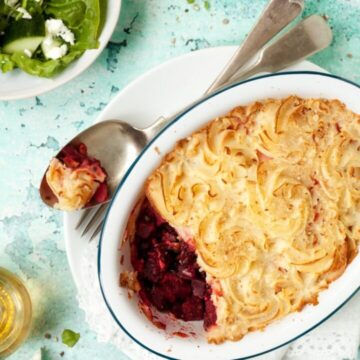 Black lentil and beetroot pie with a few spoonfuls removed from the bowl.