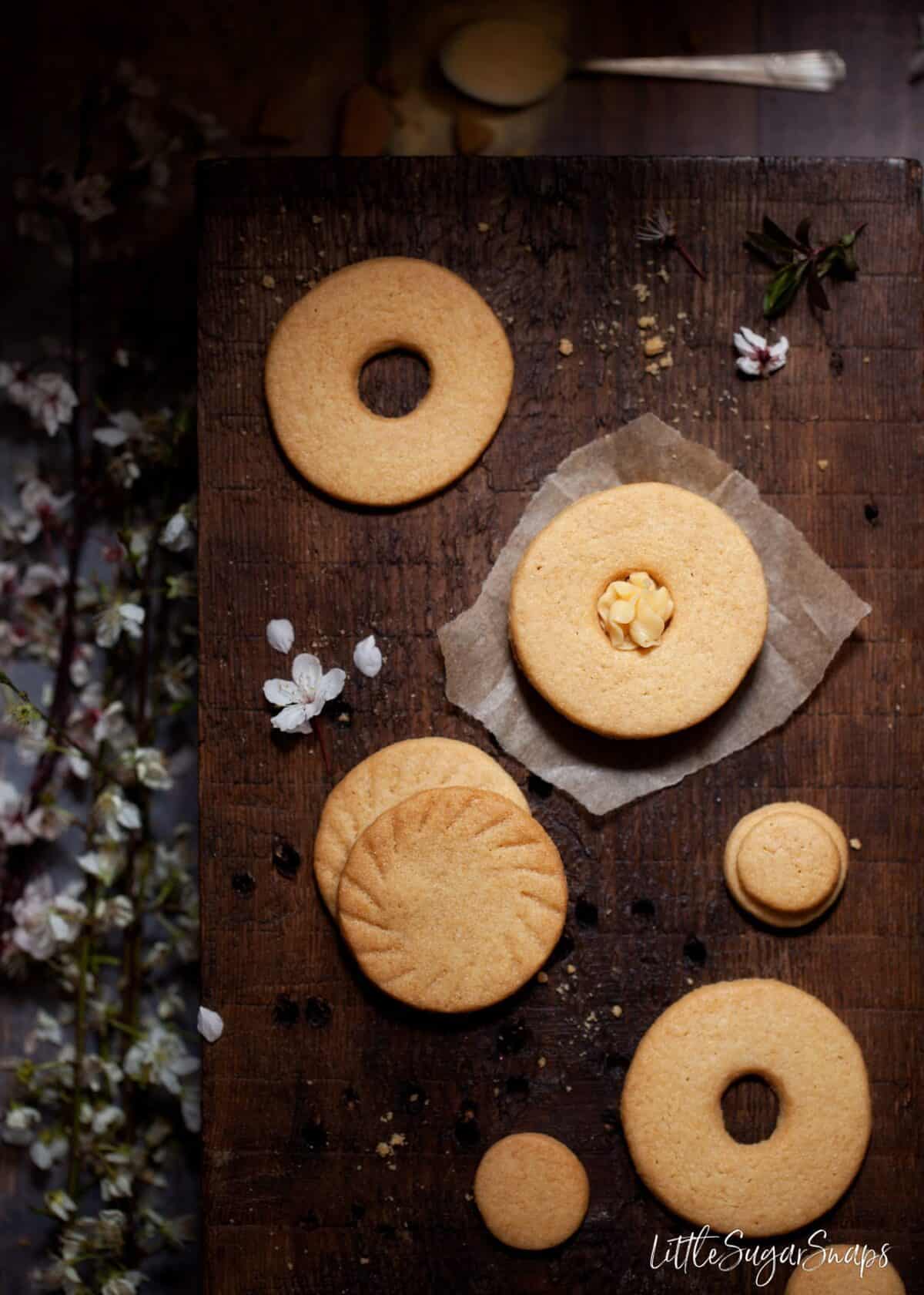 Overhead view of cookies. Some filled with buttercream, some plain.