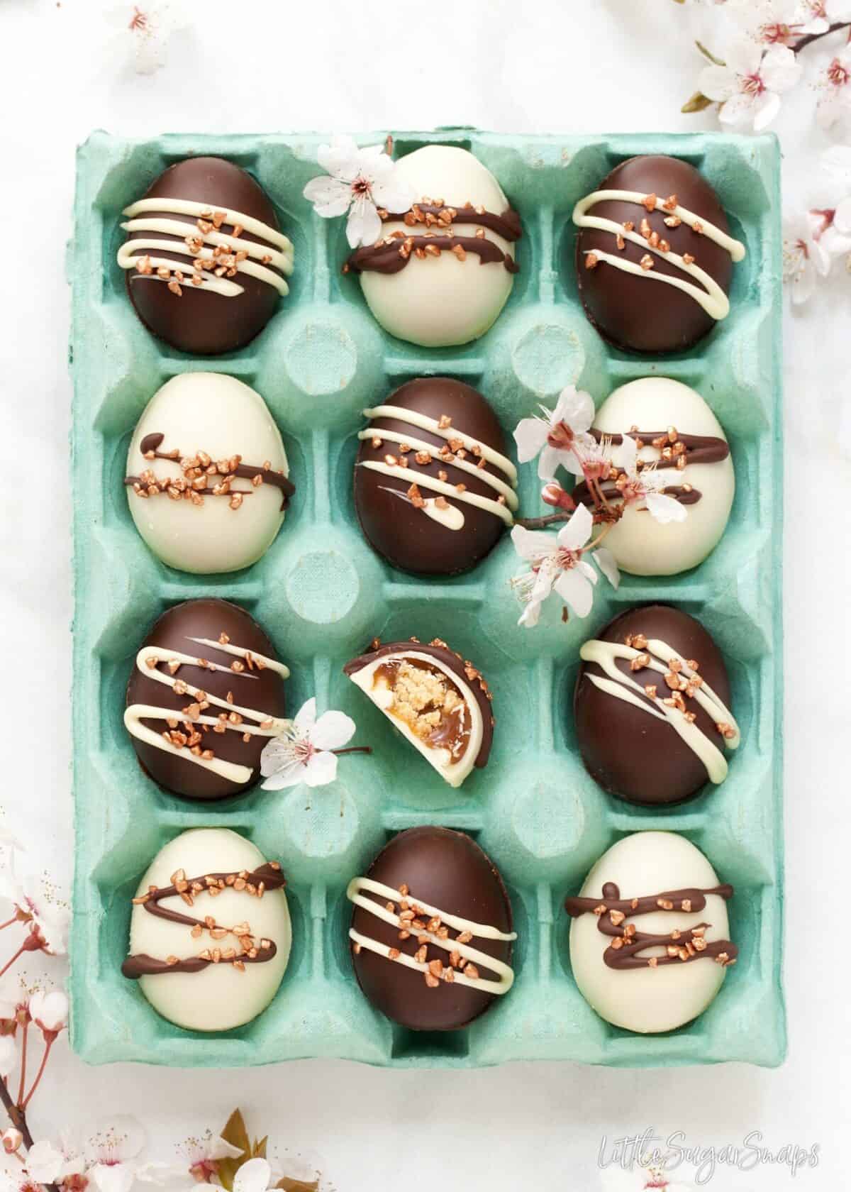 Millionaires Shortbread Caramel Easter Eggs presented in a blue egg tray.