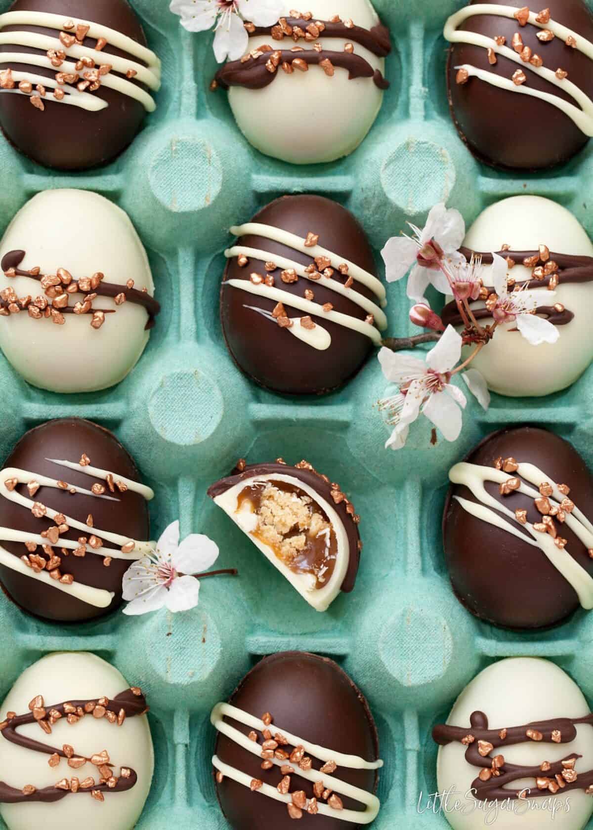 Close up of blue egg box filled with homemade chocolate easter eggs.