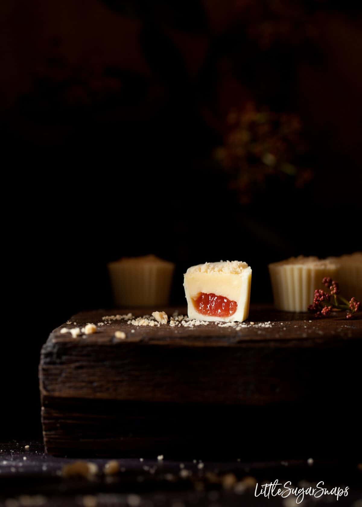 A white chocolate and rhubarb chocolate cut in half.