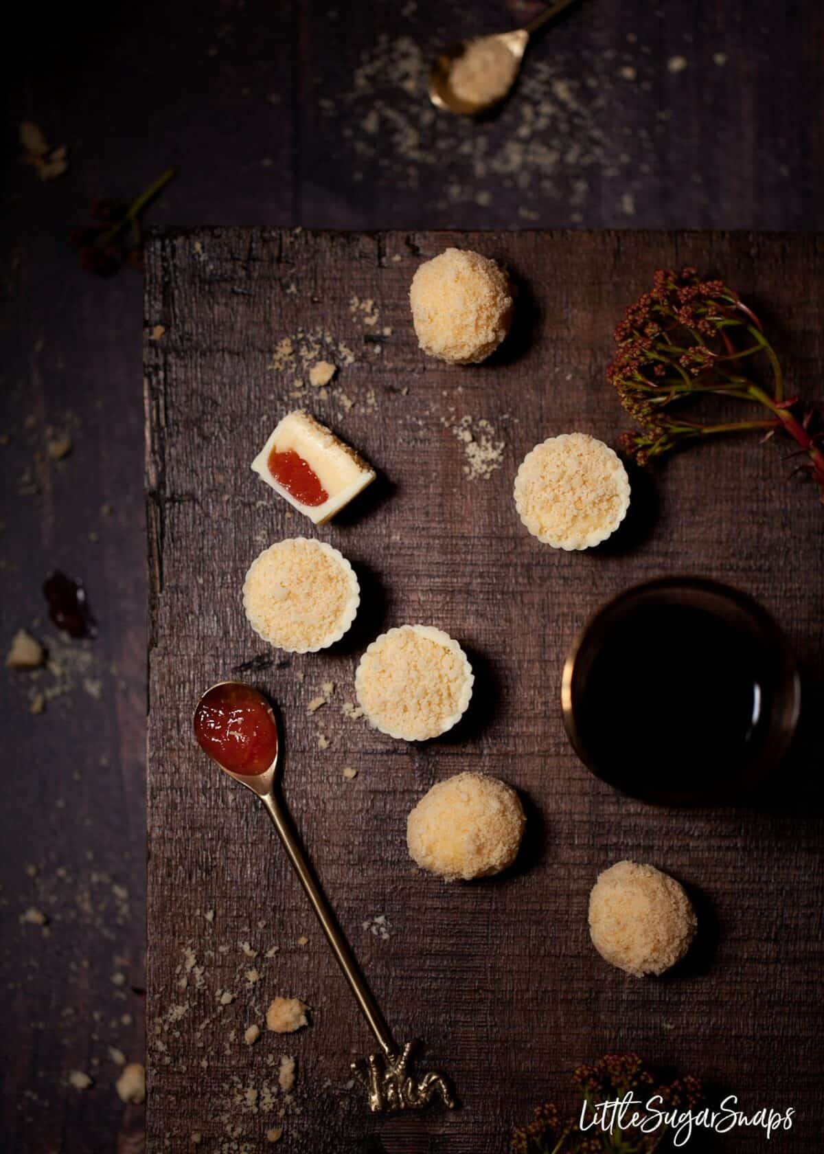 Custard Cream Truffles and a rhubarb chocolate on a tabletop.