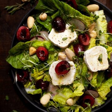 A Plate of Cherry and Goats Cheese Salad with honey dressing, radish and nuts