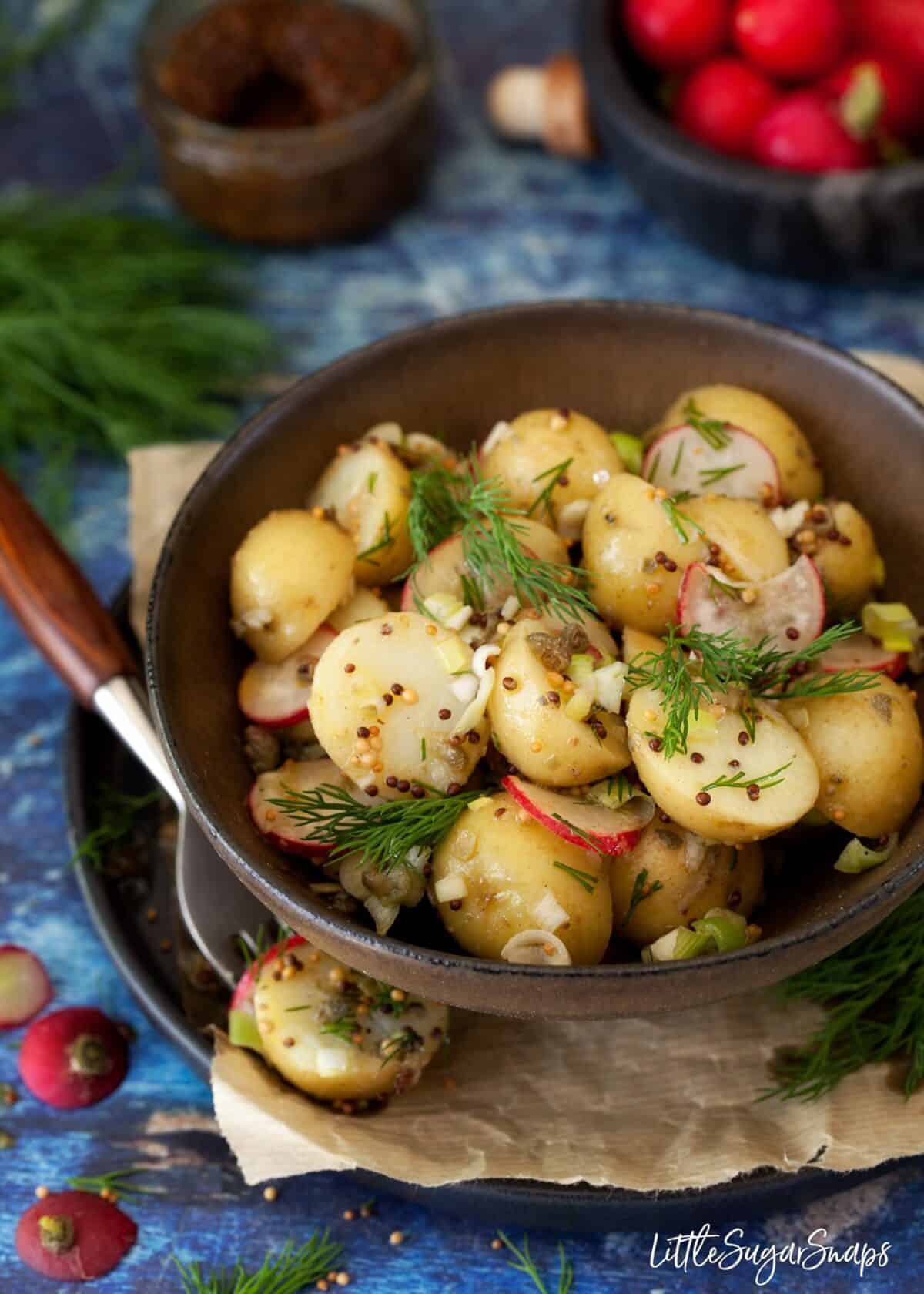 Potato salad with mustard vinaigrette, dill, radish and spring onion