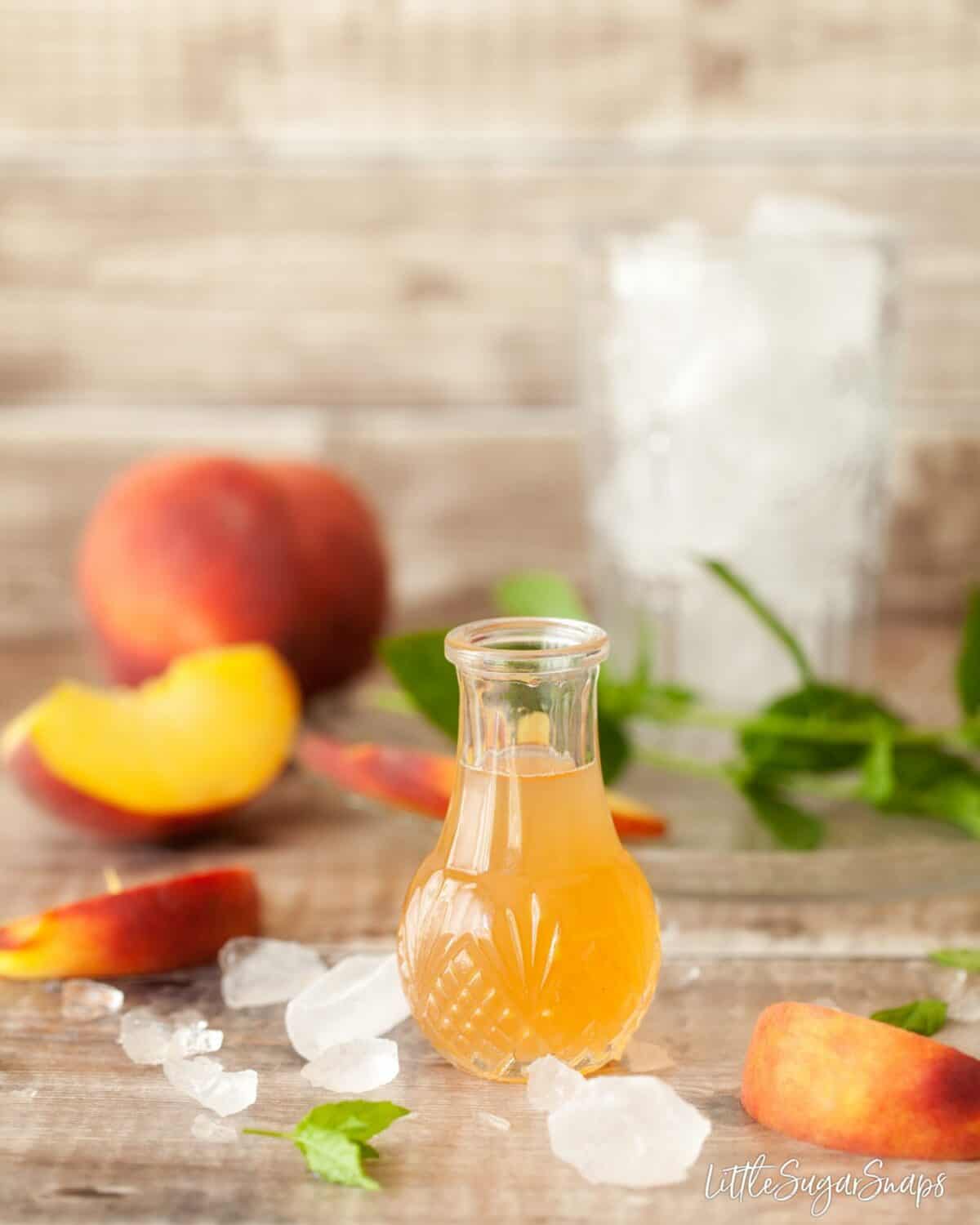 homemade peach syrup in a glass bottle