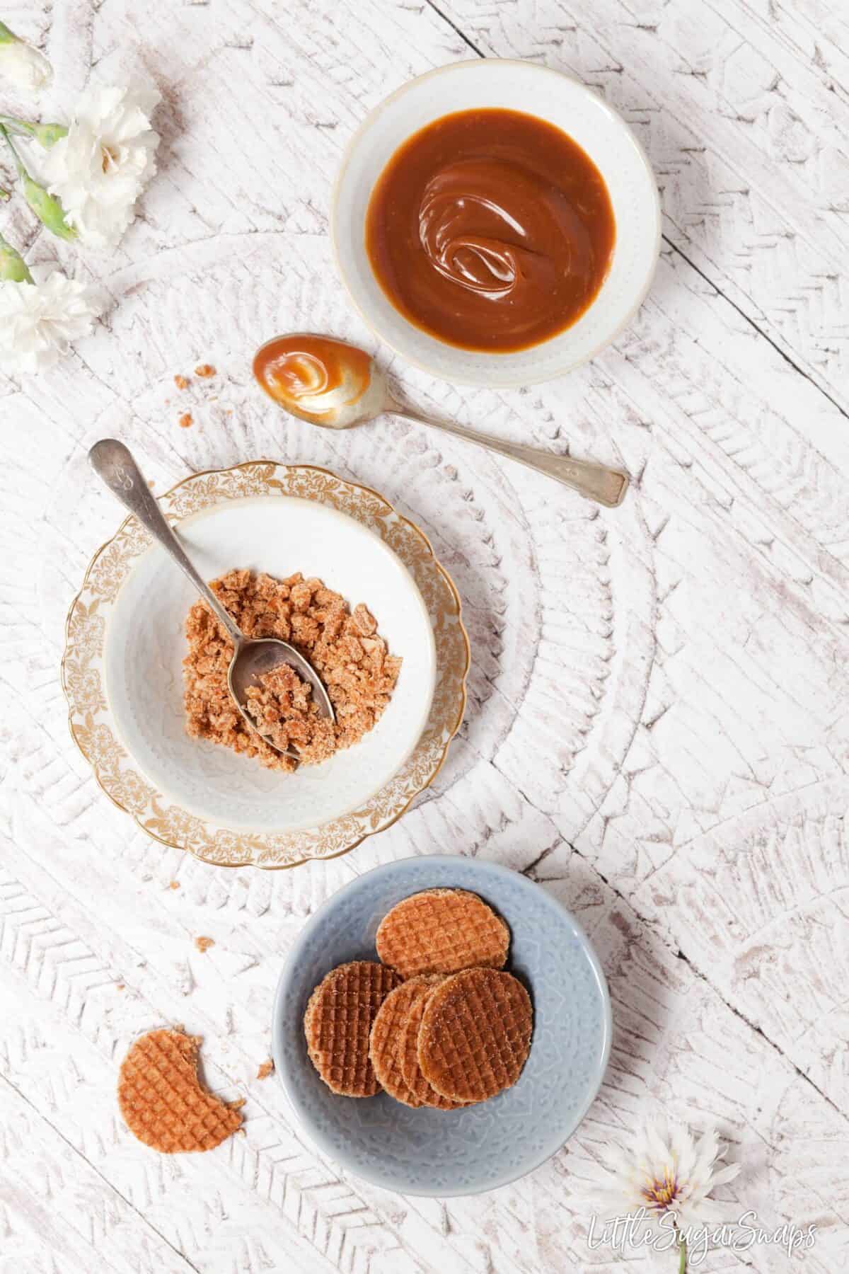 Caramel, whole caramel & waffle cookies and chopped cookies in bowls 