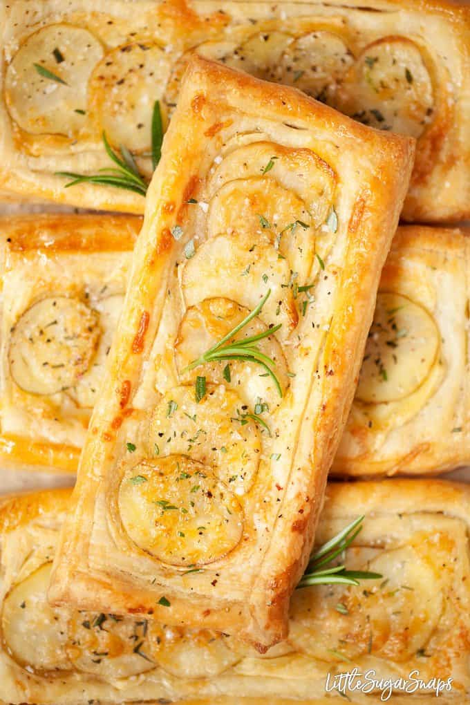 Close up image of brie and potato tarts with rosemary and sea salt on top