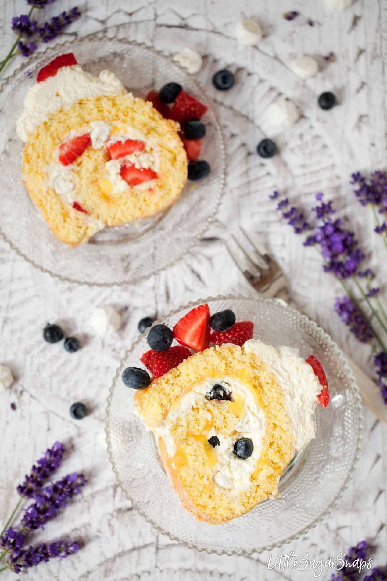 Slices of lemon meringue swiss roll with berries