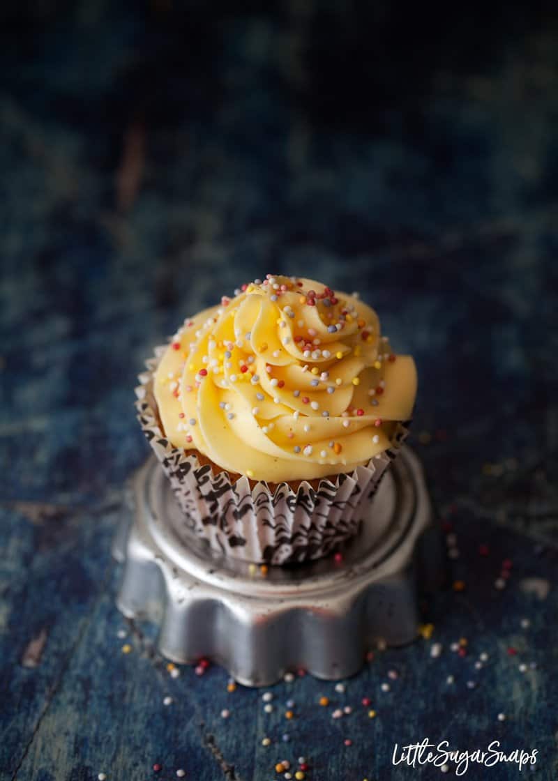 a cupcake with vanilla french buttercream and hundreds and thousands