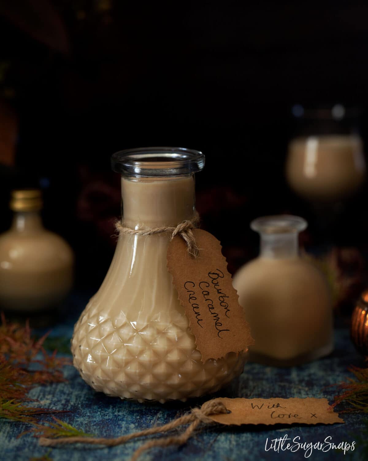 Small bottles of creamy caramel liqueur with gift tags